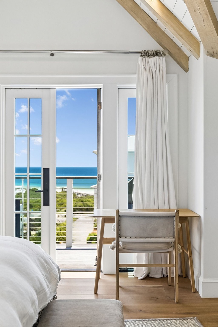 Wake up to stunning ocean views framed by bright French doors opening onto your private balcony. The breezy space blends coastal charm with serene comfort.