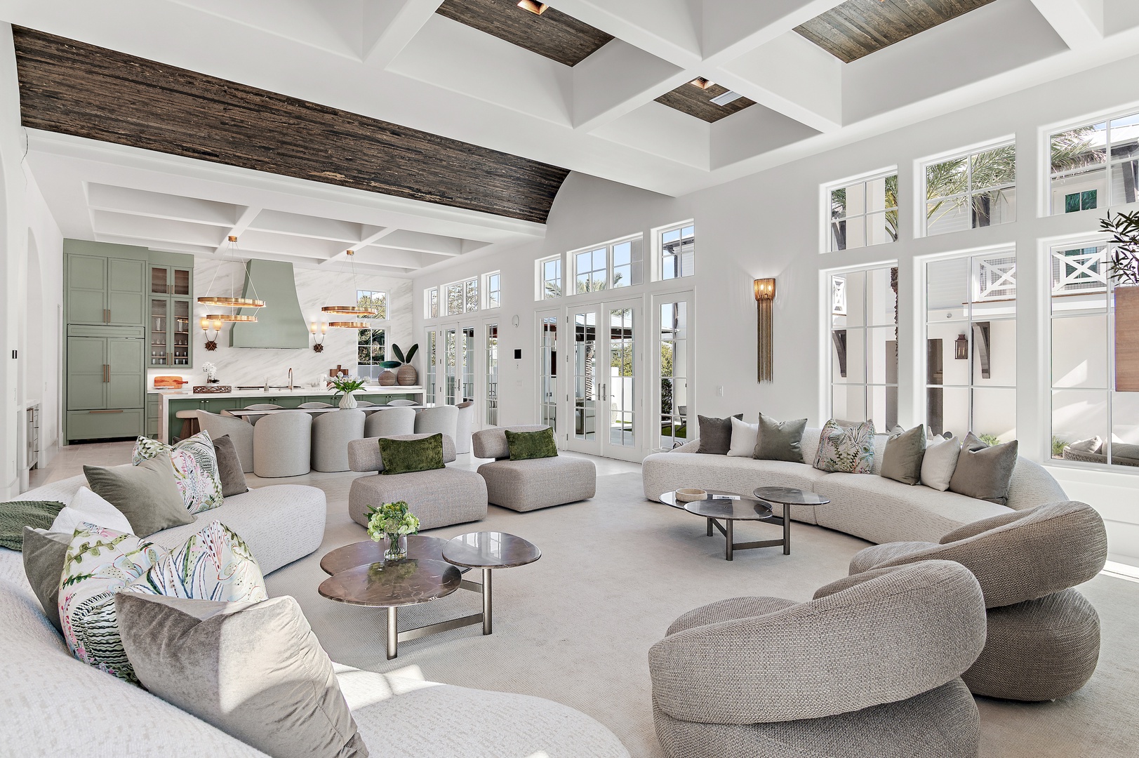 Relax in this stunning open-concept living space where natural light pours through floor-to-ceiling windows. Plush seating and elegant beams create the perfect blend of comfort and sophistication for your stay.