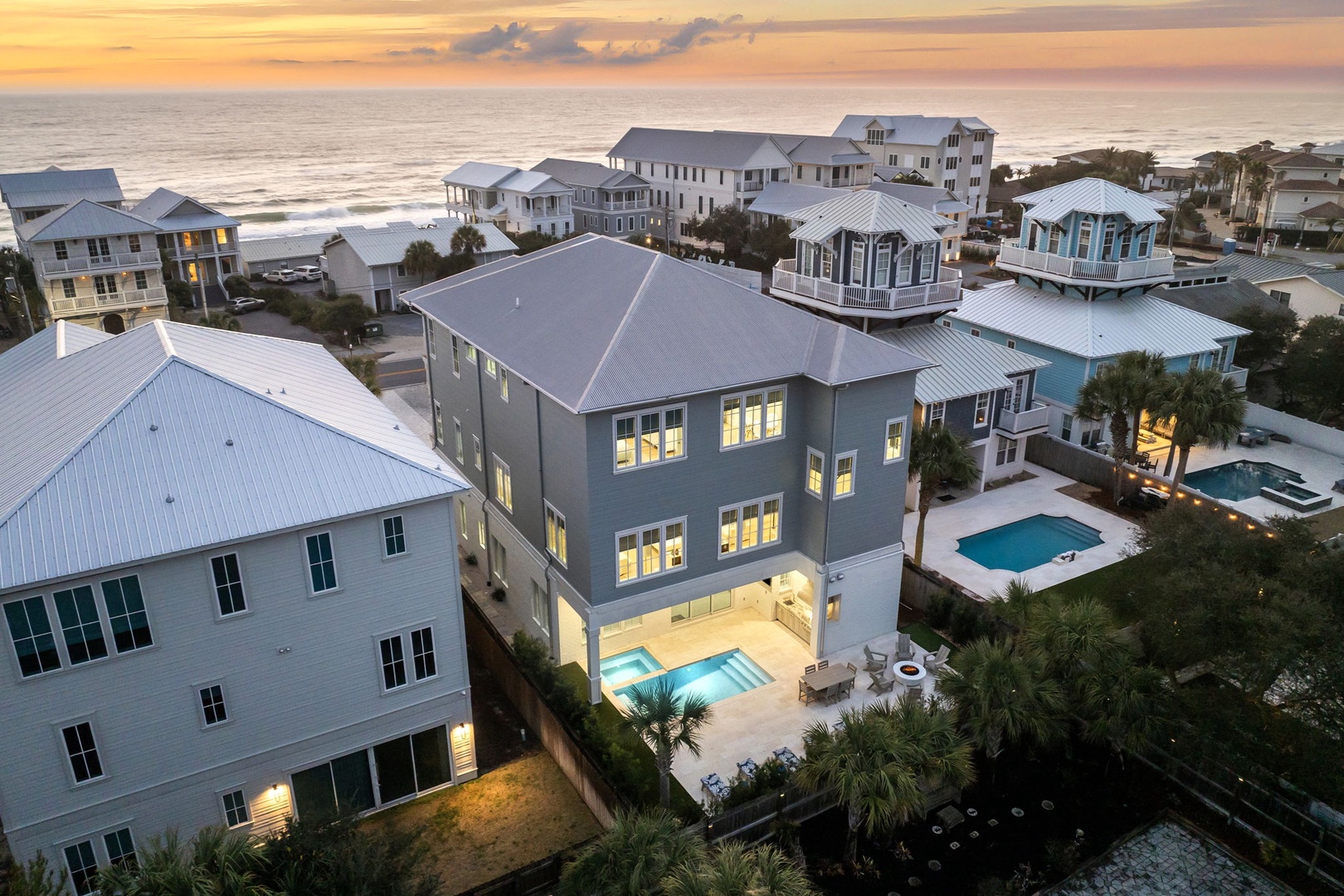 Coastal vacation rental community with beachfront properties and private pools, showcasing elevated homes with ocean access.