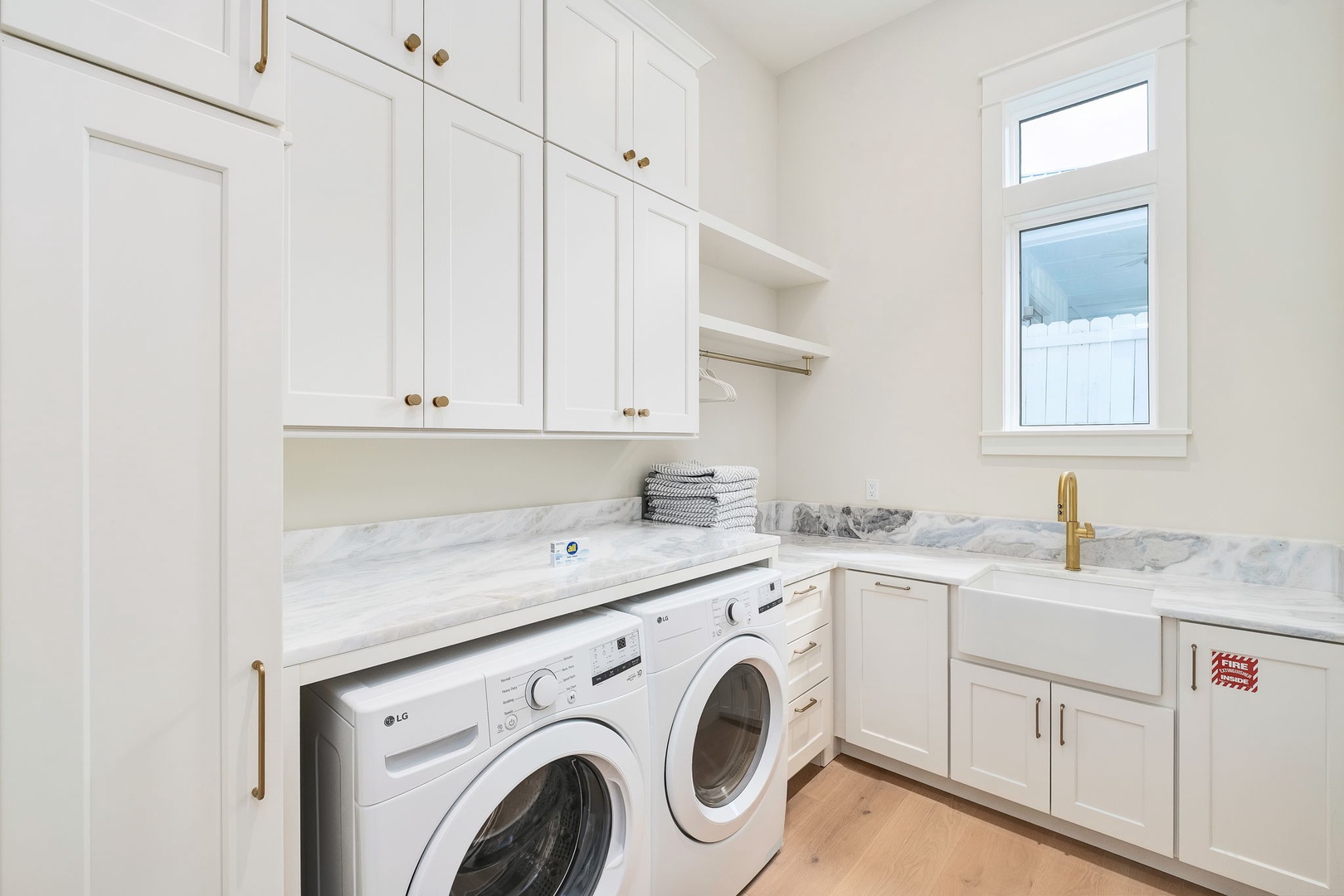 Your laundry days just got an upgrade with this bright, beautifully designed space. Marble counters and elegant cabinetry make chores feel less like work and more like part of your relaxing retreat.