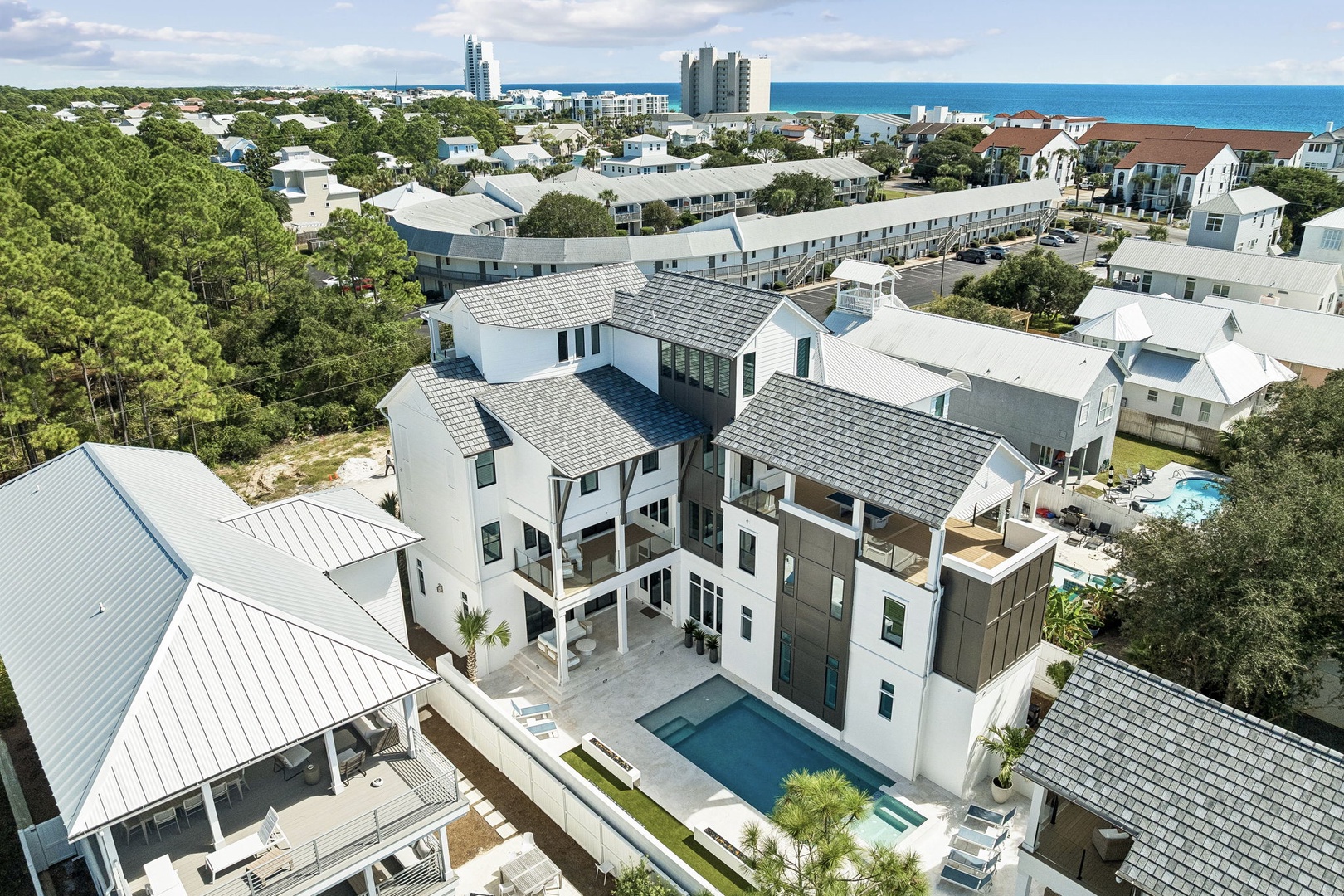 Stunning coastal property nestled among lush greenery with ocean views and a private pool, located in a serene beach community.