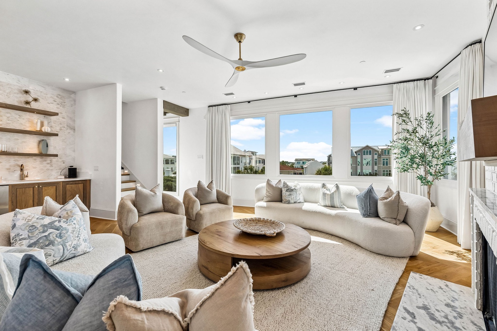 Sink into plush seating and let natural light wash over you as you relax with views of the neighborhood. Your peaceful retreat awaits in this bright, airy living space.
