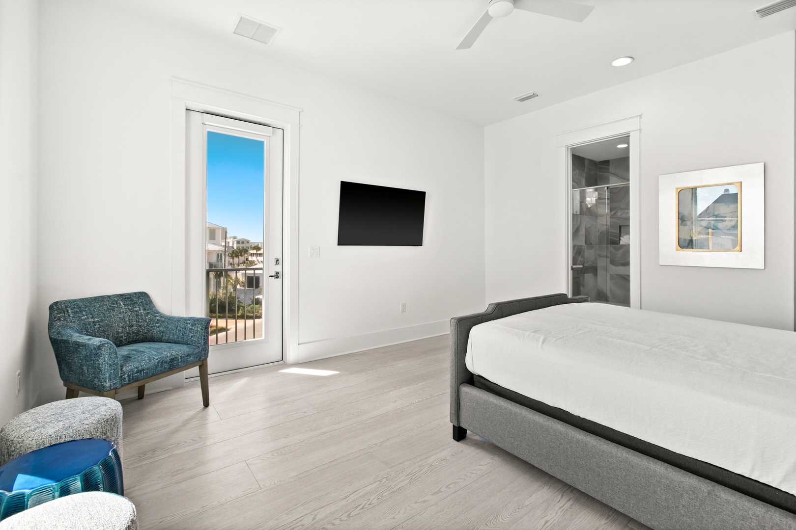 Drift off to peaceful sleep in your sunlit bedroom, where glass doors open to your private balcony and gentle breezes invite you outside, creating a seamless indoor-outdoor retreat.