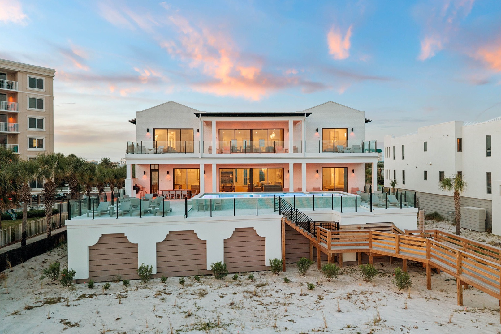 A stunning beachfront property welcomes you with direct beach access and panoramic views. The multi-level architecture features expansive glass doors opening to ocean-side decks, where your private pool awaits just steps from the sand.