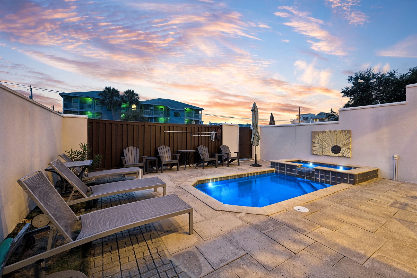 A stunning sunset paints the sky above your private outdoor retreat. Lounge poolside, soak in the glowing waters, or gather with loved ones for evening conversations under the twilight.