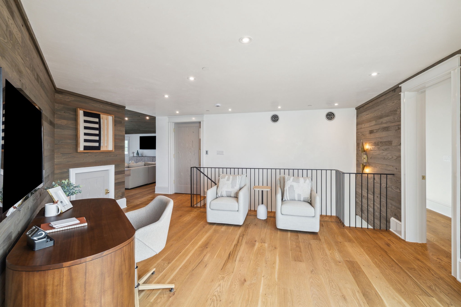 Picture yourself unwinding in this stylish loft lounge, where warm wood tones meet modern design. Sink into plush seating, catch up on your favorite shows, and enjoy the open, airy feel of your private retreat.