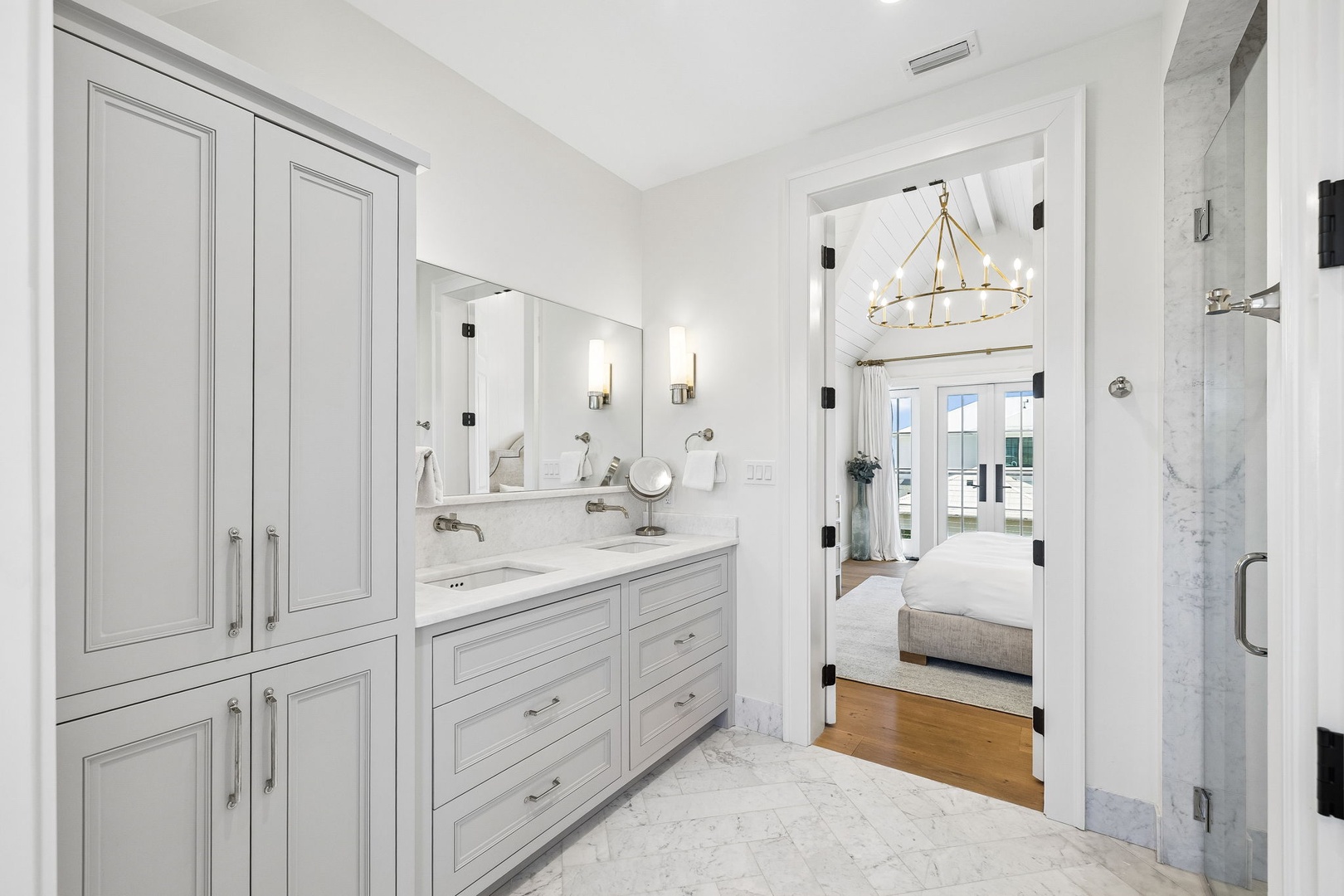 Your private sanctuary awaits: a serene spa-like bathroom with marble finishes, a luxurious walk-in shower, and ample storage for all your essentials.
