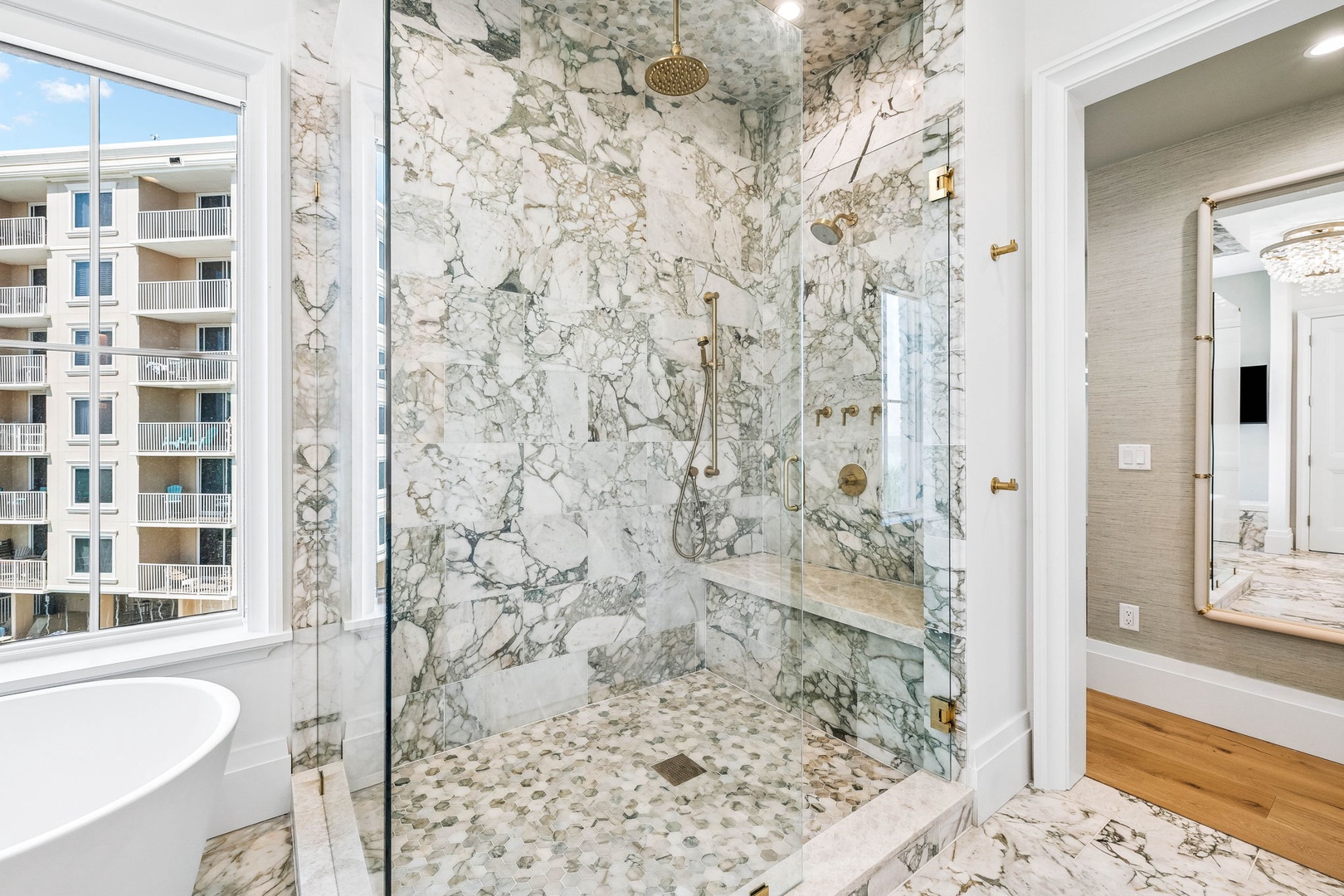 Step into your luxurious spa-like shower, where stunning marble surrounds you in elegance. The rainfall showerhead and gleaming fixtures promise pure relaxation after a day of coastal adventures.