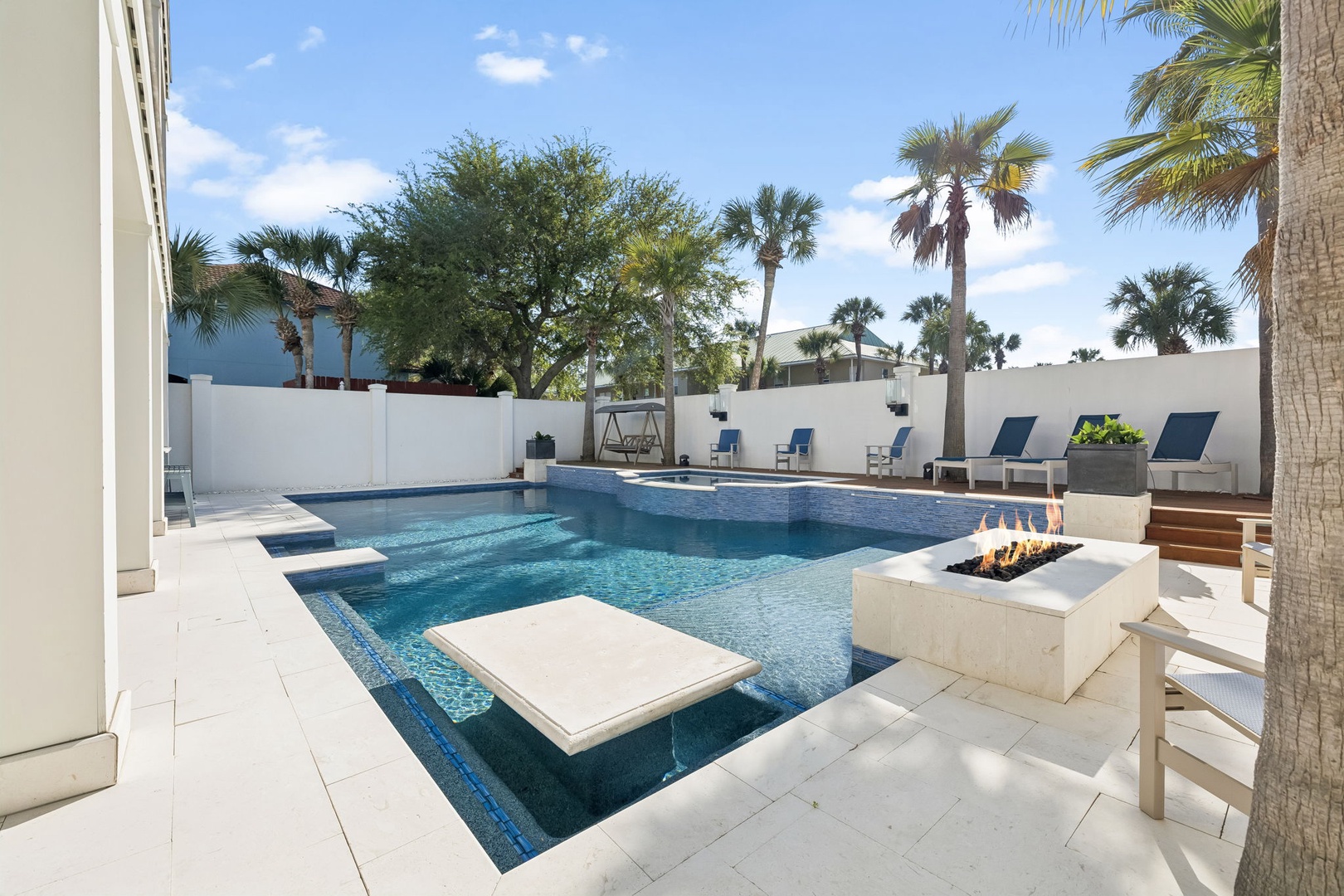 Dive into your private pool paradise, complete with a fire pit for cozy evenings under the palm trees.