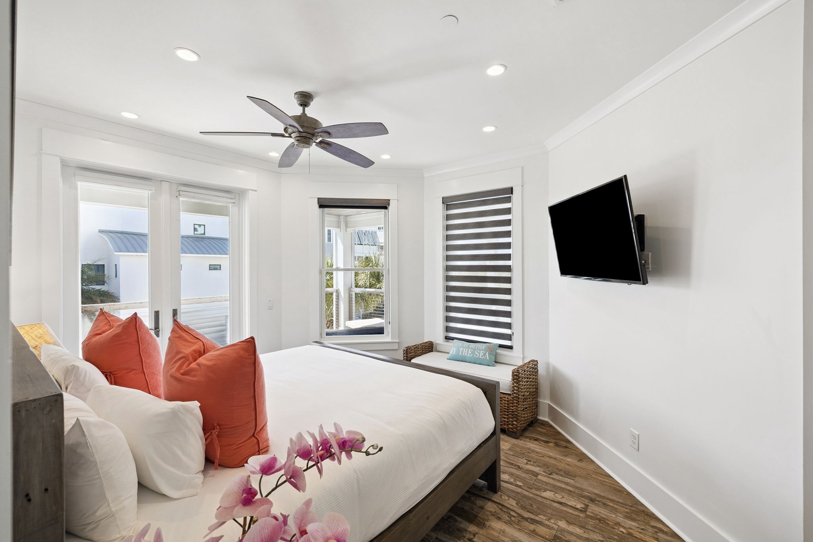 Drift off in your serene bedroom with crisp linens, ocean breeze from the ceiling fan, and coastal views framing your peaceful retreat.