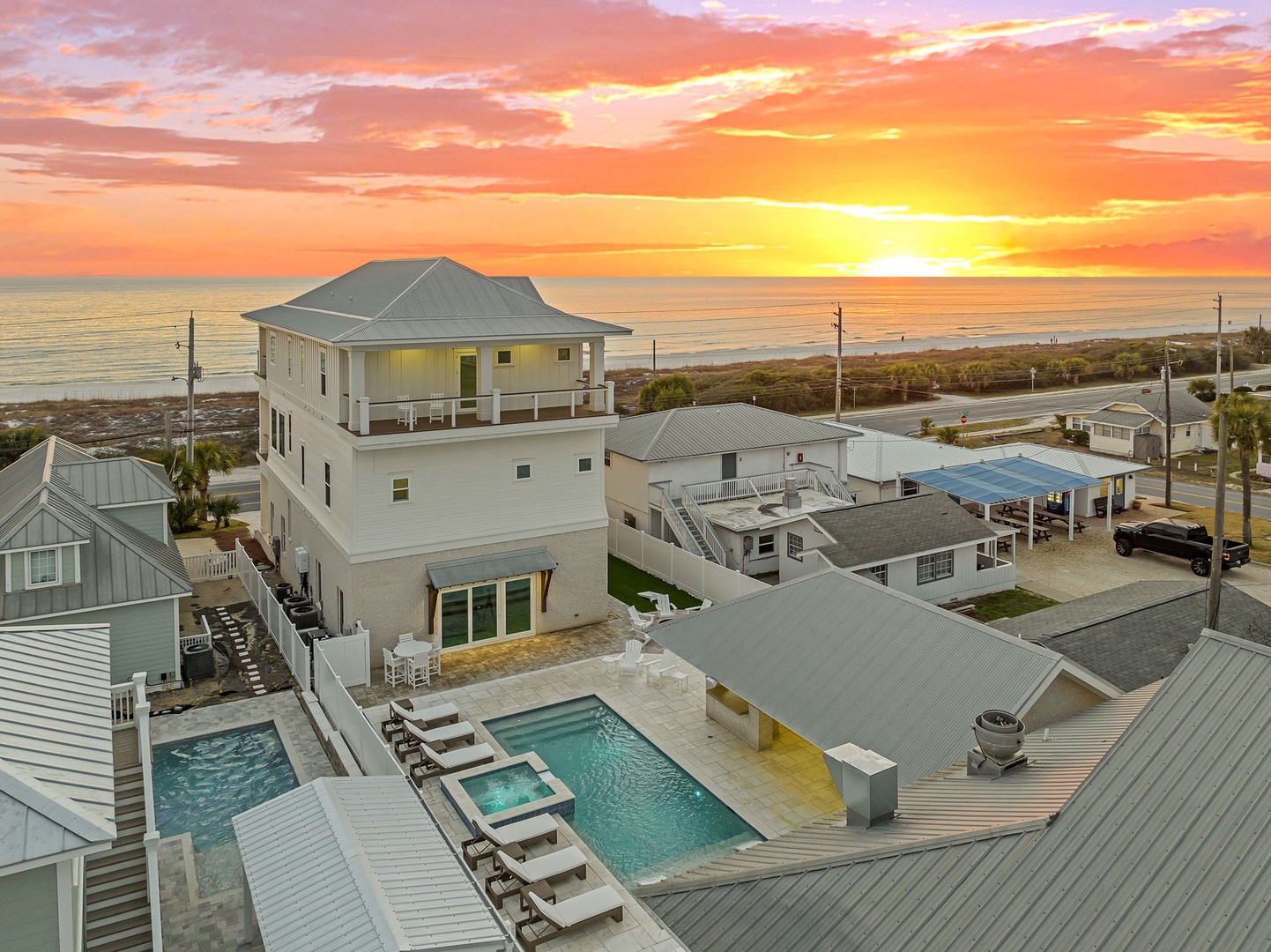 Spectacular oceanfront property with private pool area captures breathtaking sunset views over the water from this prime beachside location.