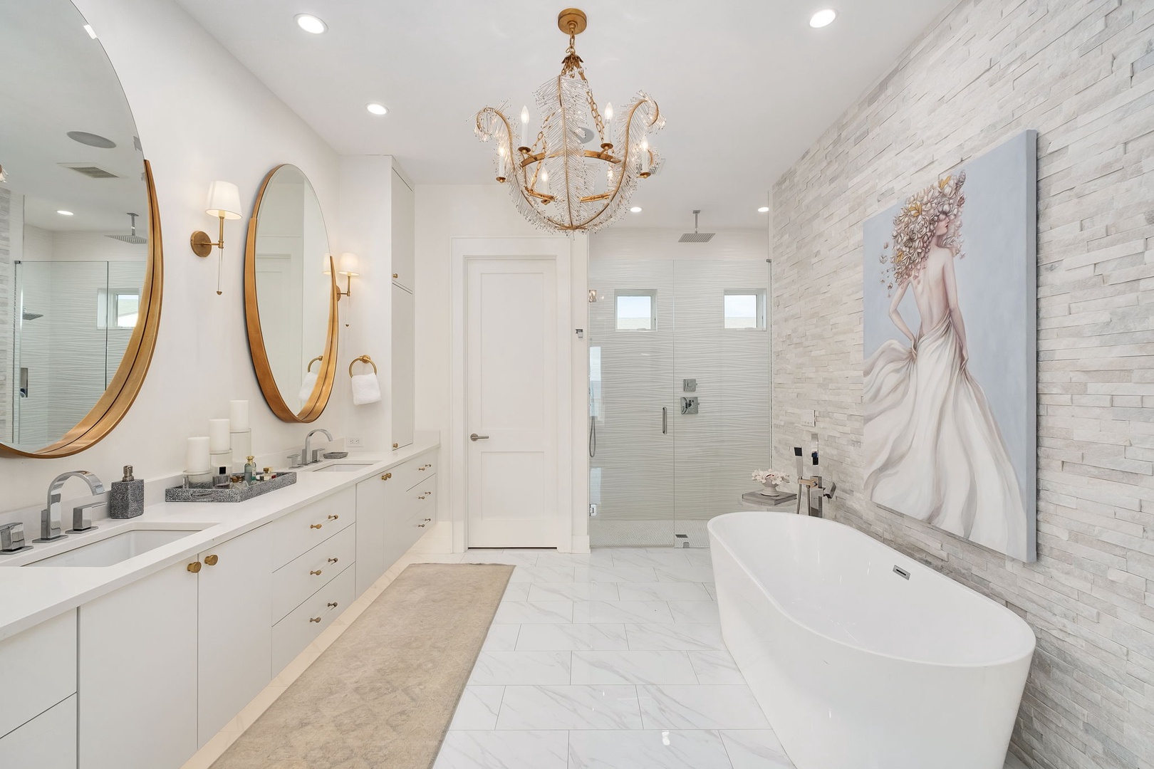 Step into your luxurious spa-like sanctuary featuring elegant dual vanities, a soaking tub, and glass-enclosed shower with refined finishes throughout.
