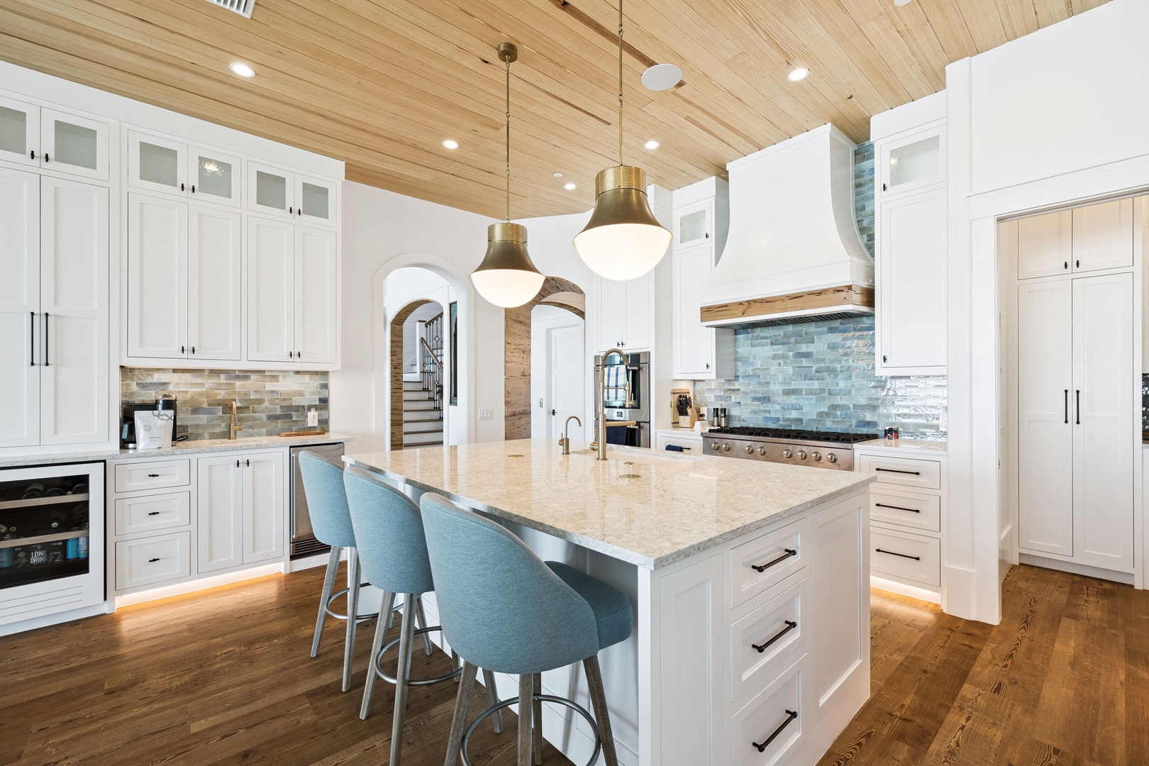 Your spacious kitchen features white cabinetry, granite countertops, and a large island perfect for cooking and gathering together.