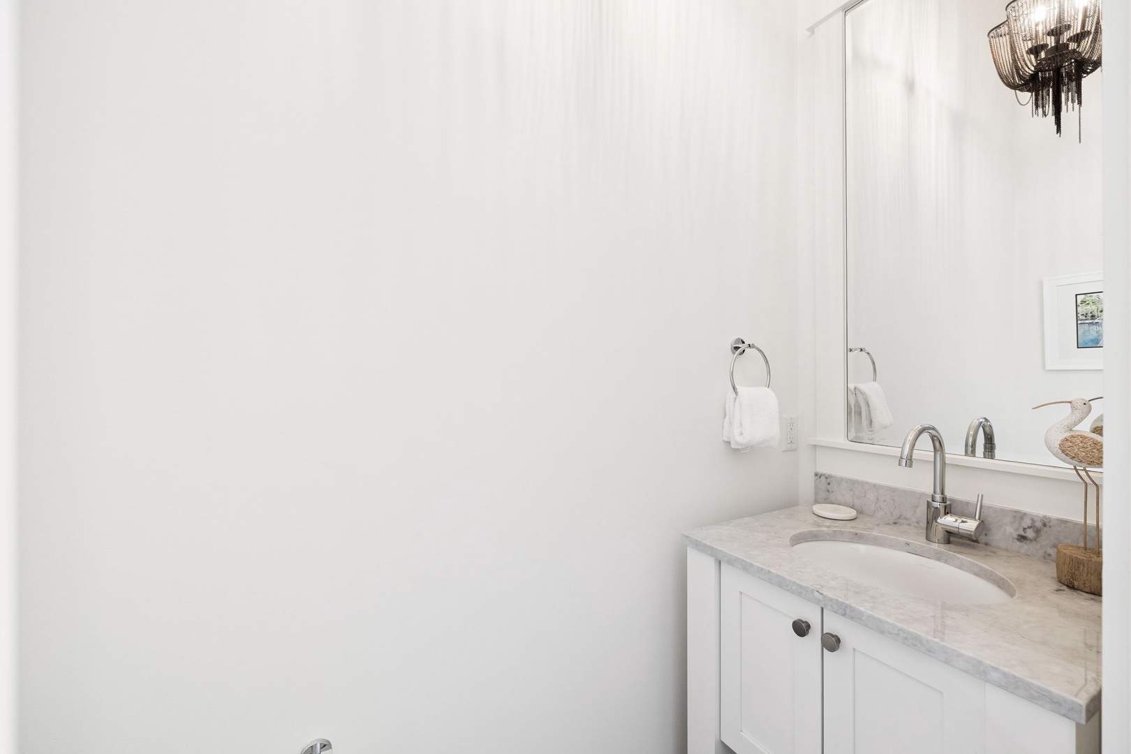 Refresh in your bright, spotless bathroom featuring marble countertops, plush towels, and elegant fixtures for your daily routine.