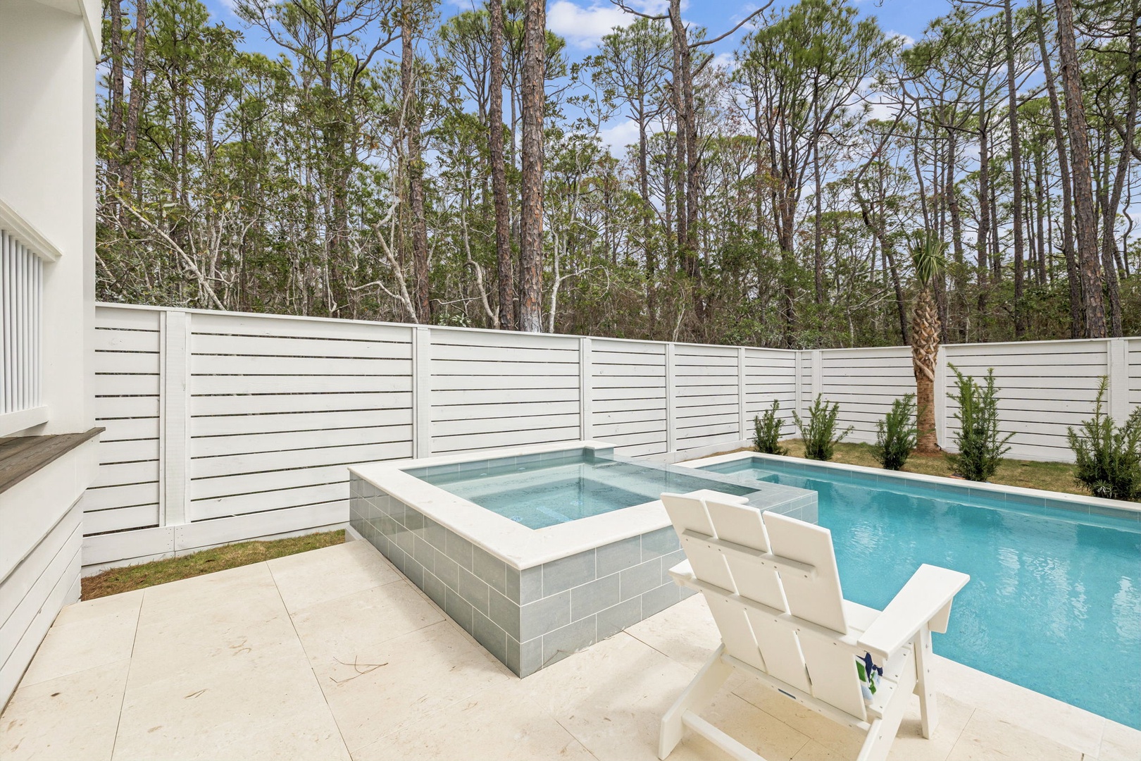 Your private oasis awaits with a sparkling pool and spa surrounded by lush forest views for ultimate relaxation.