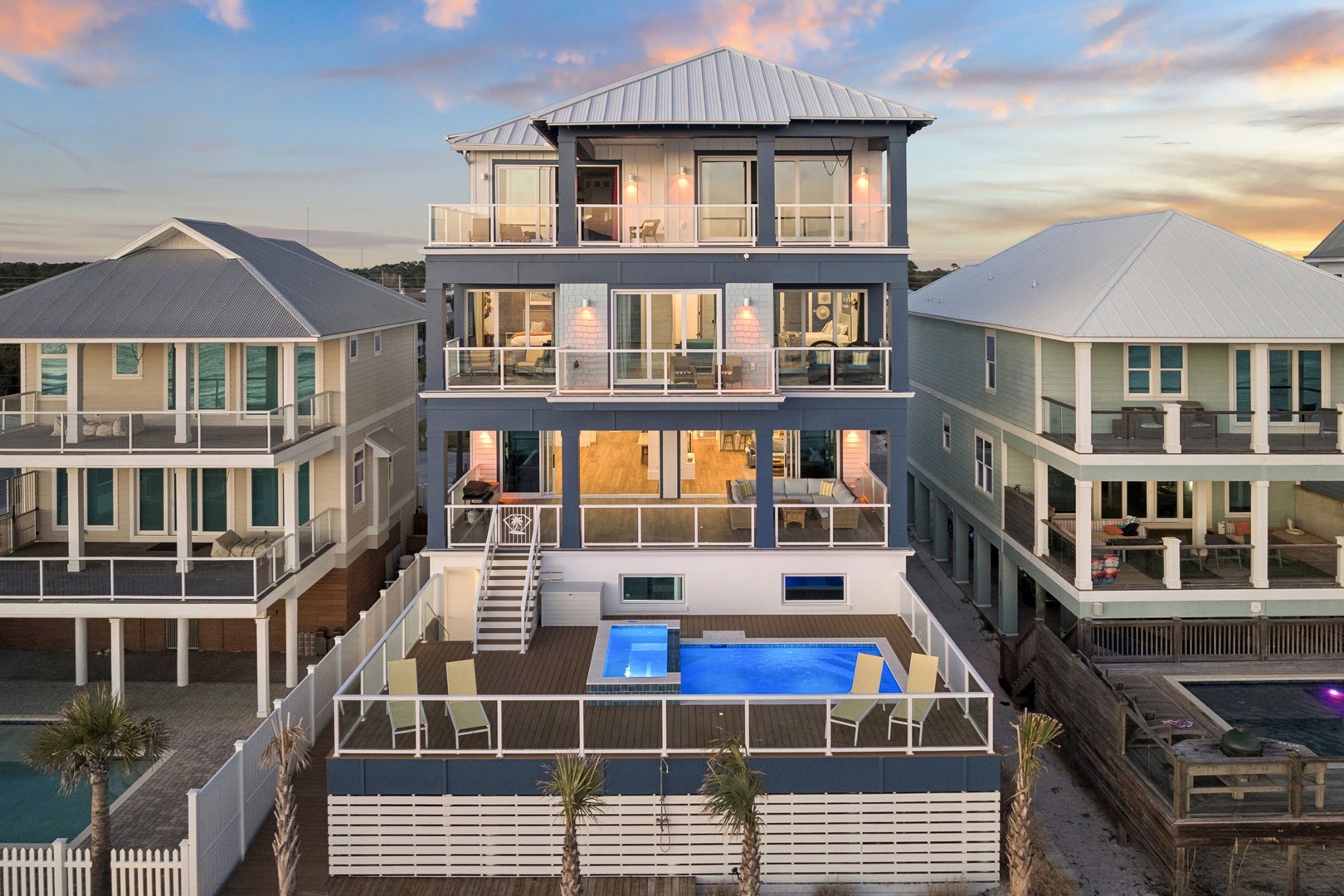 Contemporary beachside vacation home featuring multiple levels of living space with private pool and deck area in coastal community setting.