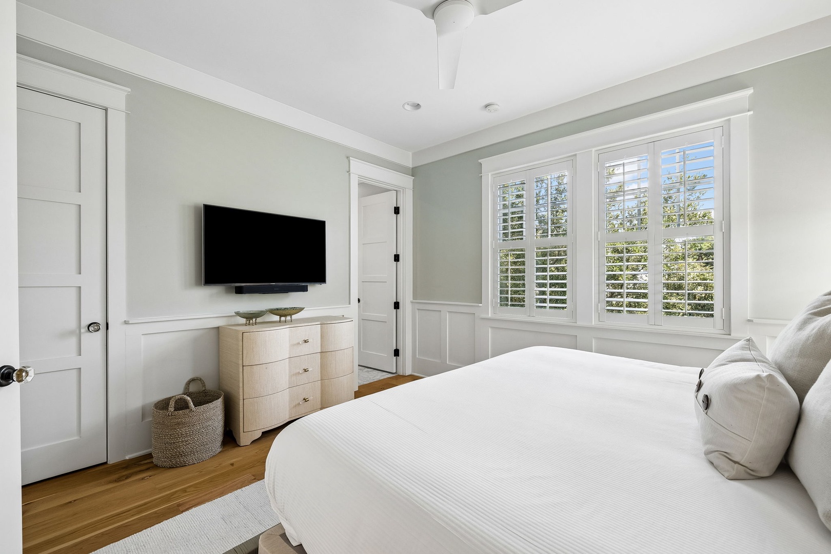 Slip into crisp, white linens and wake to greenery through the plantation shutters. Your coastal-inspired bedroom has classic charm with warm wood floors and a ceiling fan for gentle breezes.