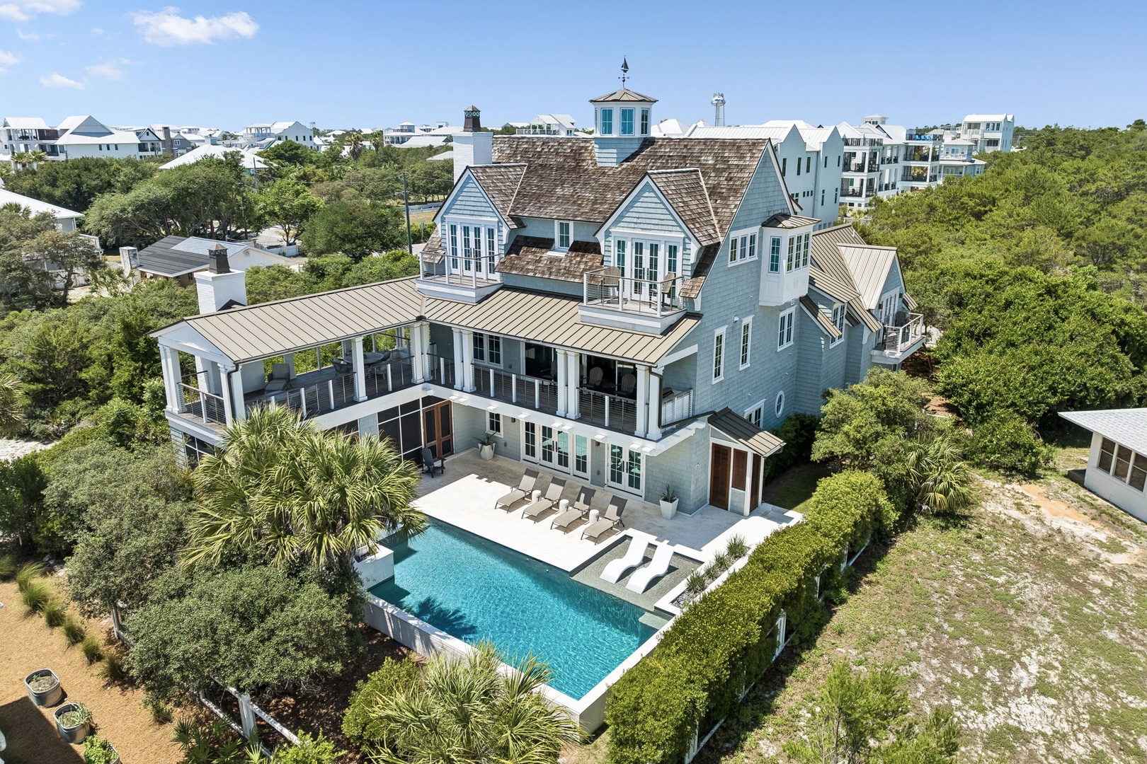 This stunning coastal property sits nestled among lush greenery in a charming beach community, featuring a sparkling pool and modern architecture with easy access to nearby attractions.