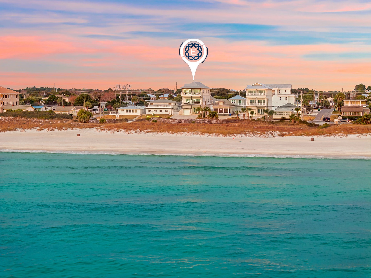 Property location with pristine turquoise waters and sandy shore during golden hour.