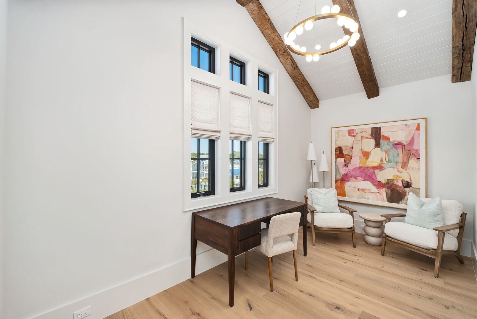 Your private workspace features exposed wooden beams, elegant furnishings, and stunning natural light streaming through tall windows.