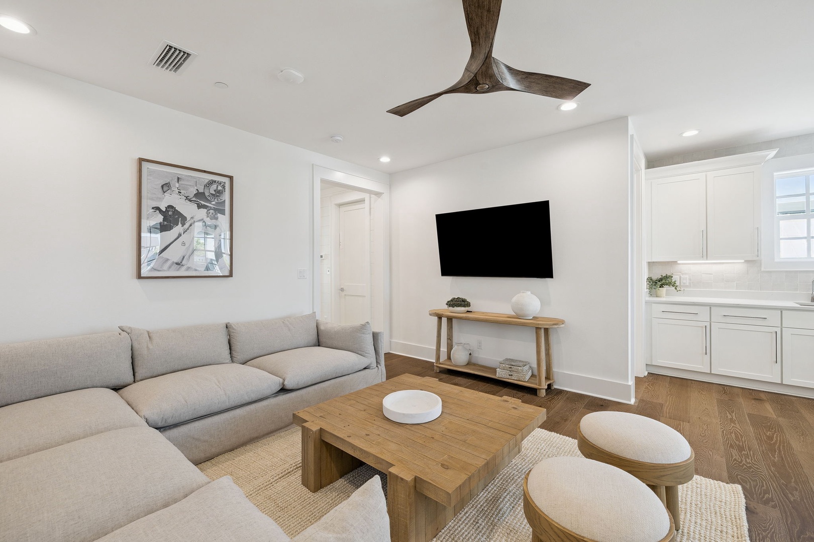 Sink into your plush sectional as gentle ceiling fan breezes keep you cool. The sleek TV awaits your favorite shows.