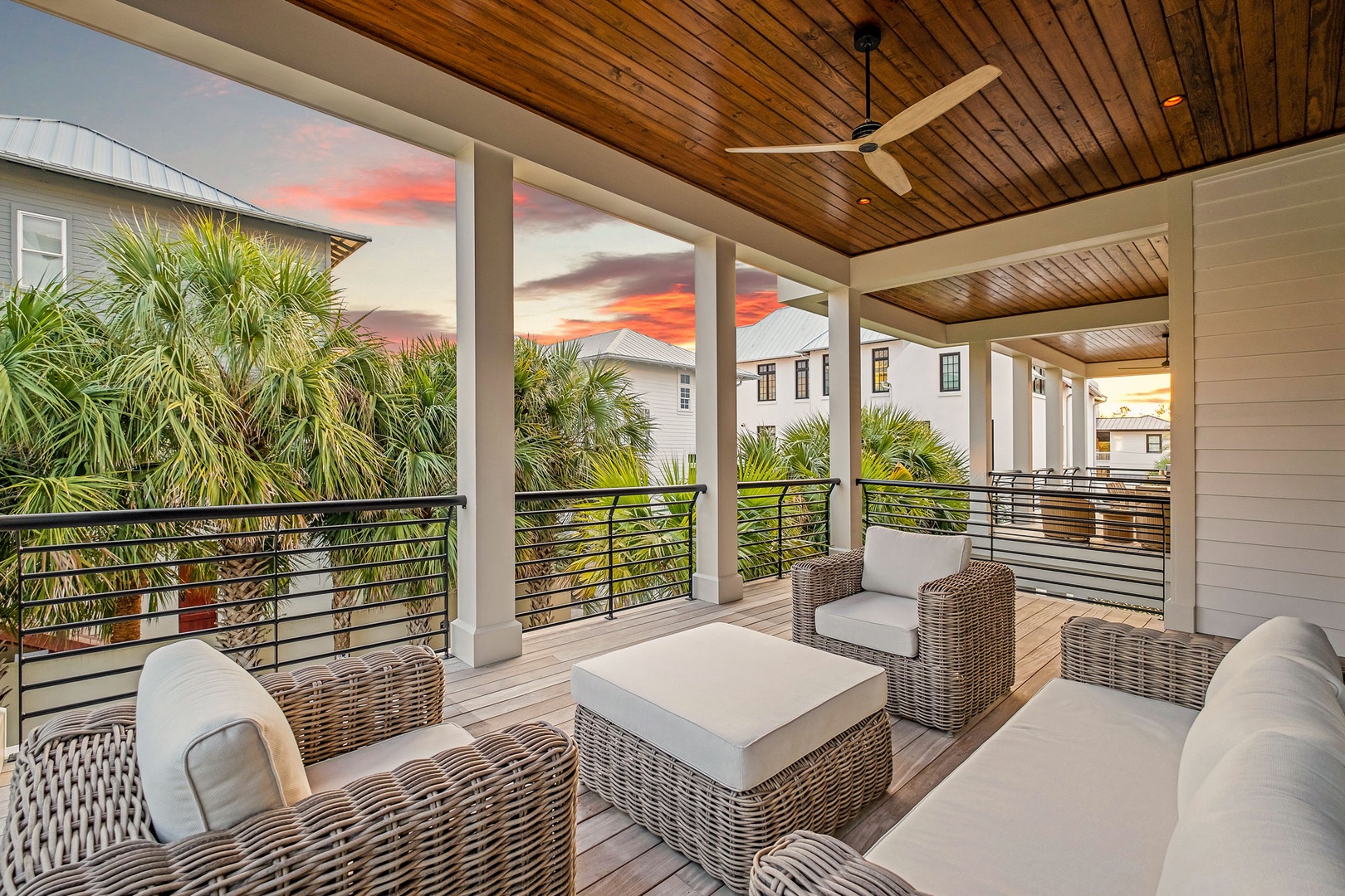 Unwind in your private covered terrace with stunning sunset views over tropical palms and coastal homes.
