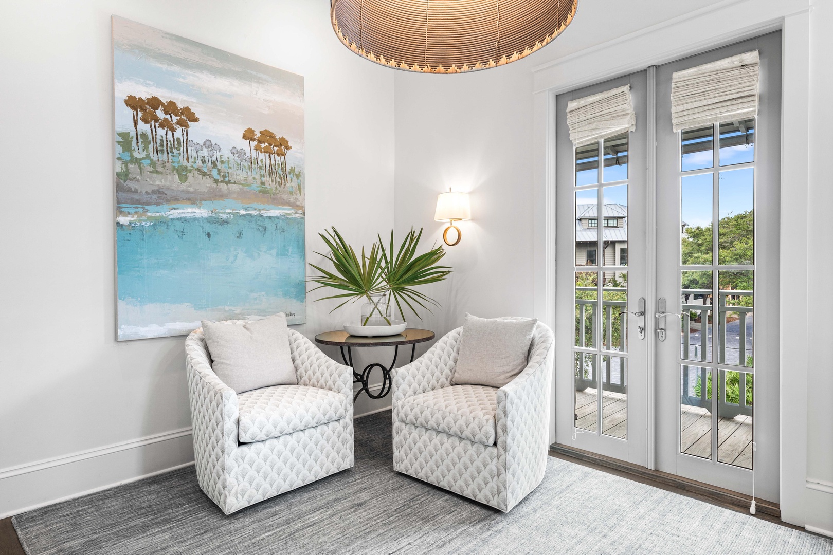 Sink into these plush chairs where coastal artwork meets natural light streaming through French doors to your private balcony.