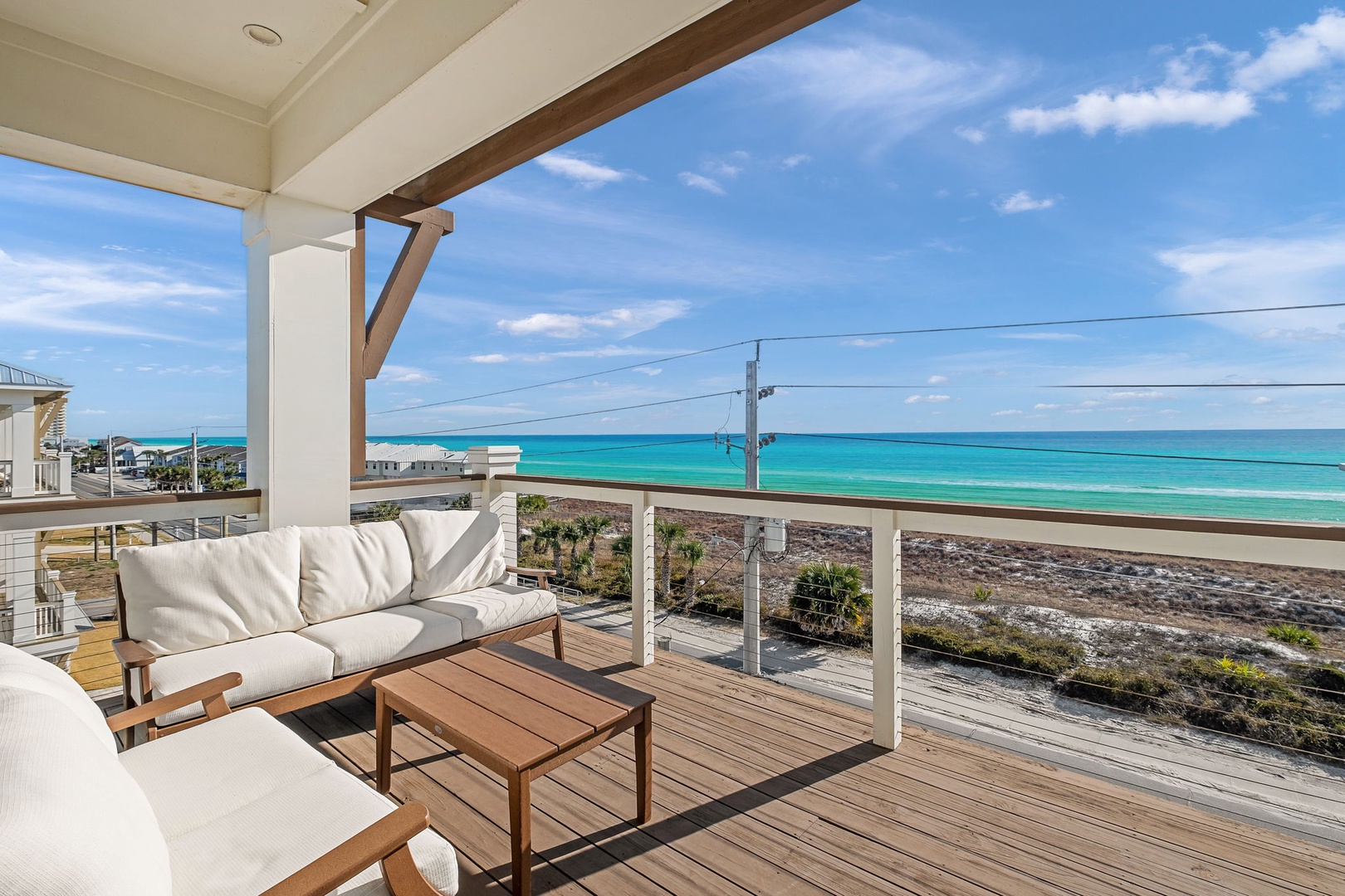 Sink into plush cushions on your private deck and soak in endless turquoise ocean views stretching to the horizon.