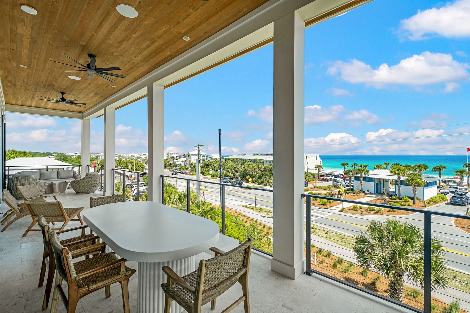Relax on your spacious covered terrace with stunning turquoise ocean views, just steps from the beach and coastal charm.