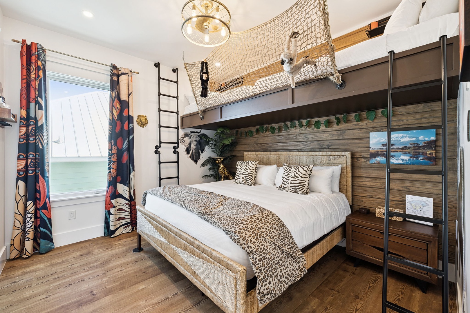 Your adventure-themed bedroom features a cozy bed below and exciting loft space above, connected by a climbing net for endless fun.