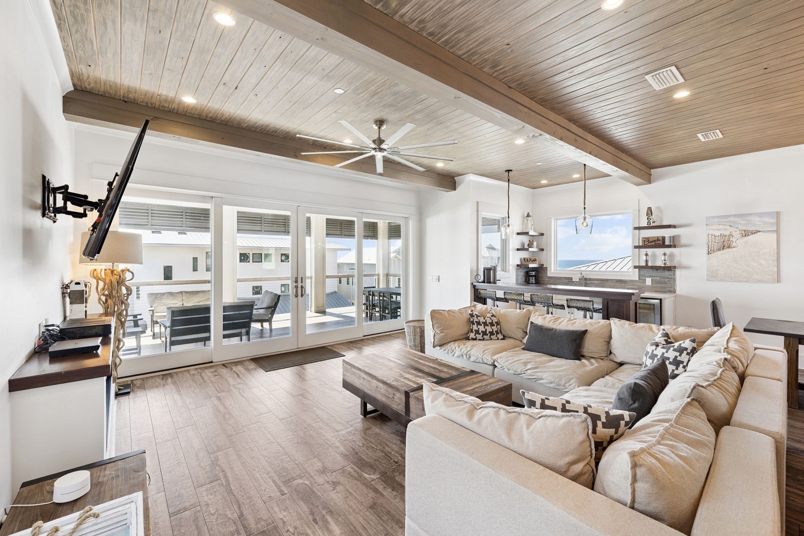 Sink into your spacious sectional and enjoy the stunning wood beam ceiling while natural light pours through expansive windows.