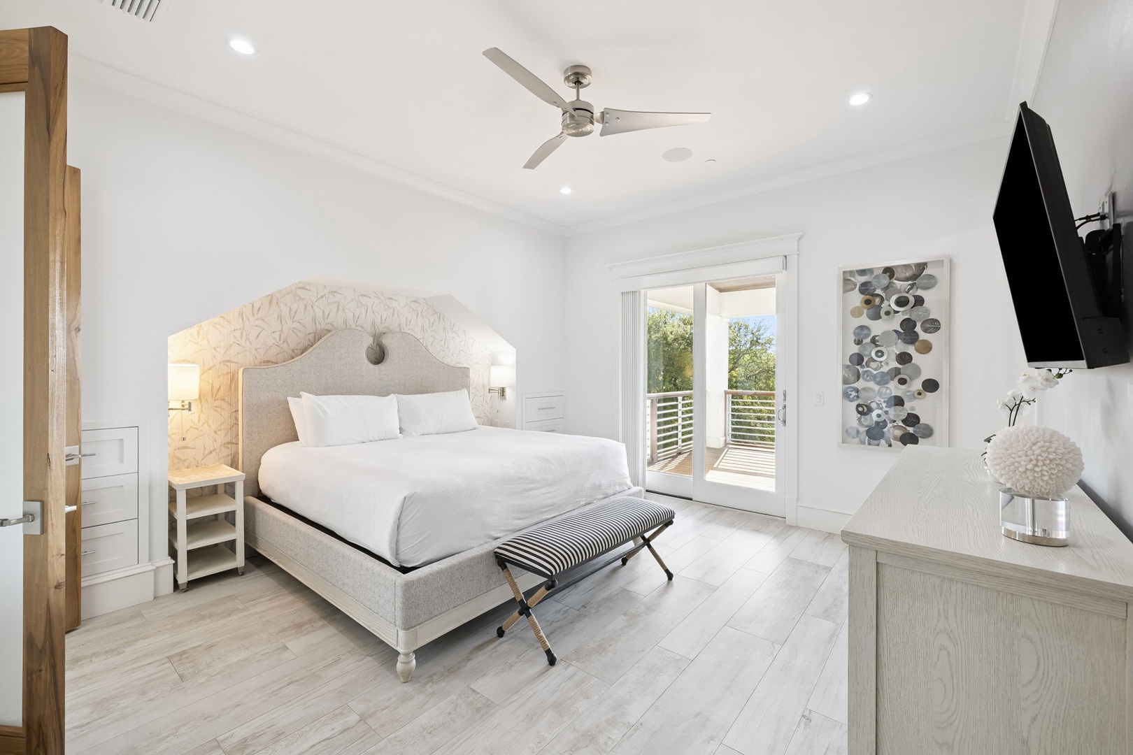 Relax in your elegant bedroom featuring a plush king bed, private balcony access, and modern amenities for the perfect retreat.