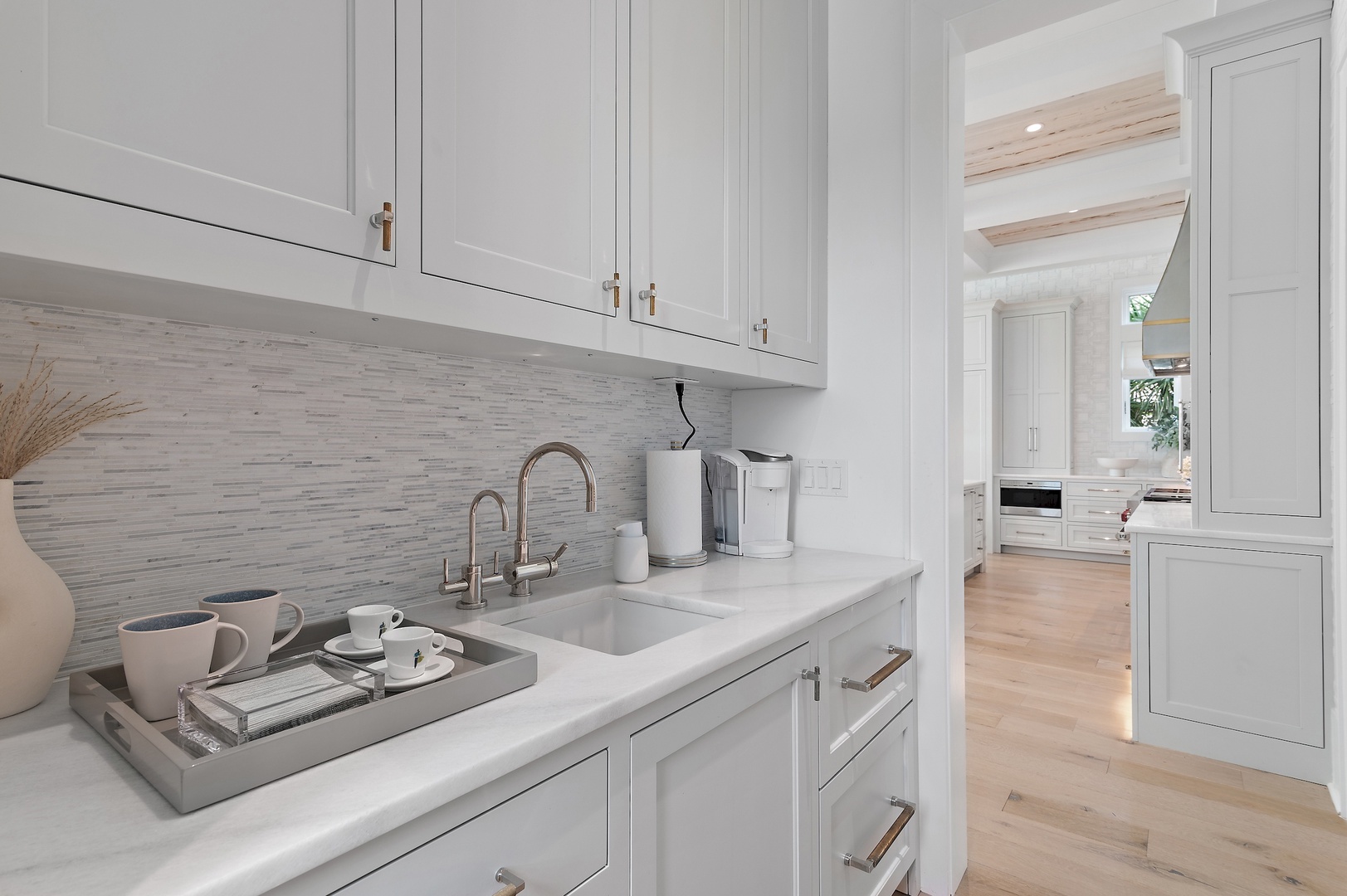 Your private butler's pantry awaits, with elegant cabinetry, gleaming countertops, and a thoughtfully stocked coffee bar—perfect for leisurely mornings or evening tea. Every detail is here to make you feel at home.