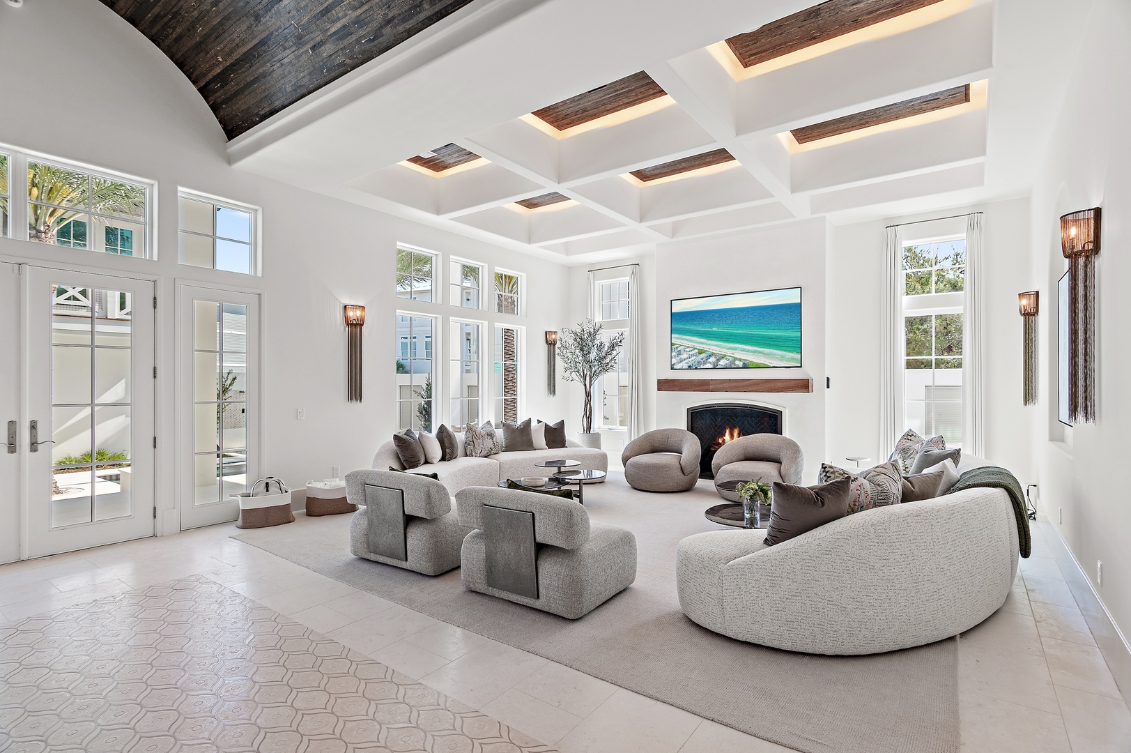 Sink into plush sofas in this bright, airy living room where dramatic wood-beamed ceilings and coastal artwork create your elegant retreat.