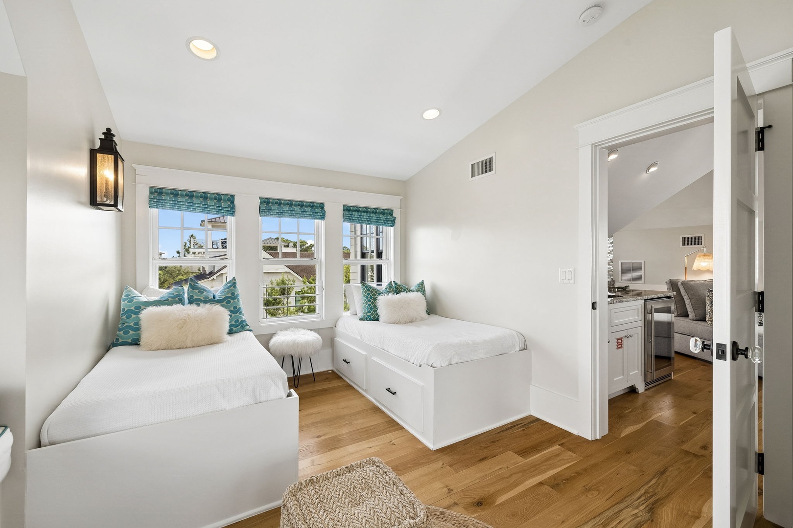 Drift off in crisp white linens with coastal breezes and neighborhood views filling your bright retreat.