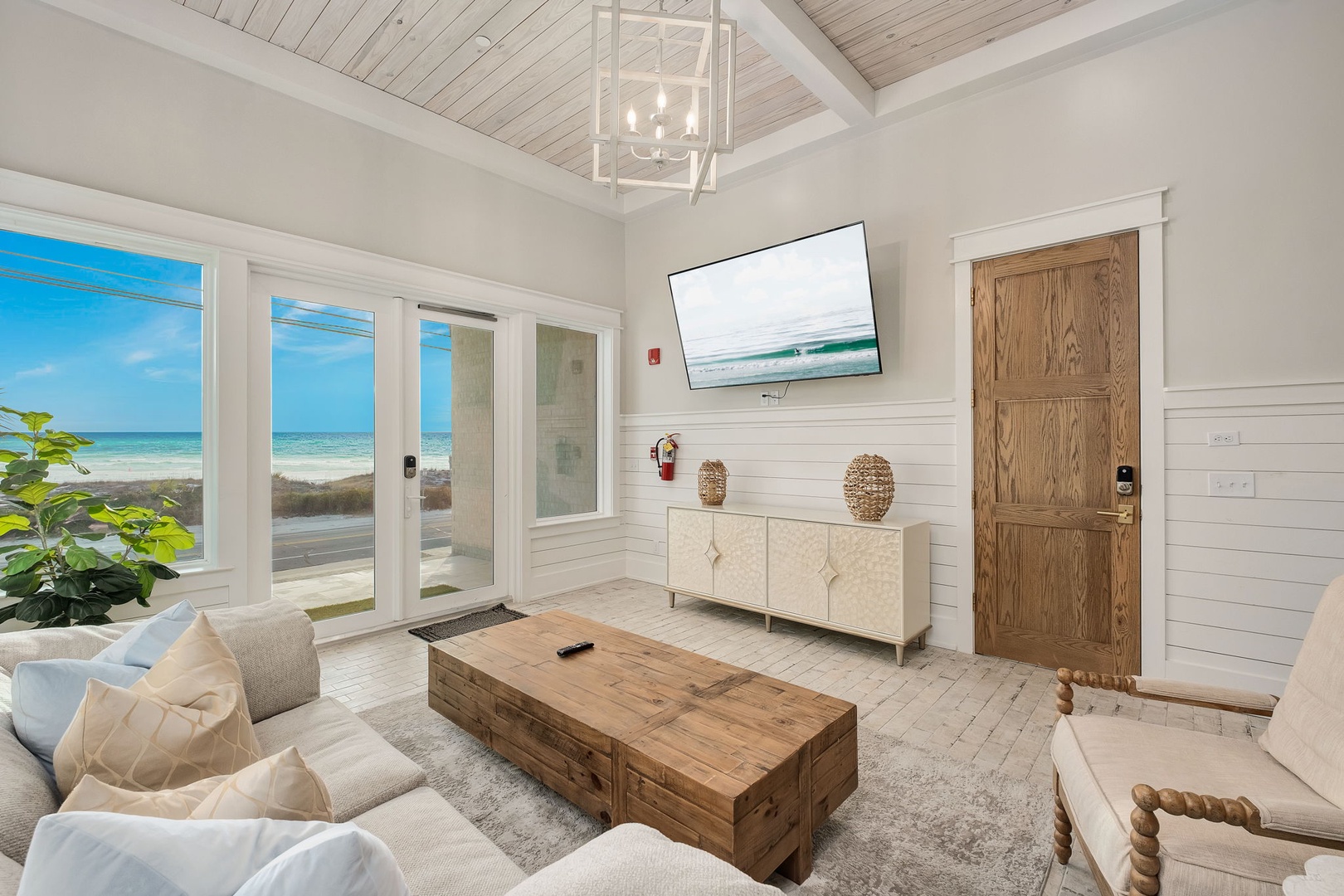 Unwind in your bright living space where ocean views through floor-to-ceiling windows create the perfect backdrop for relaxation and memorable moments.