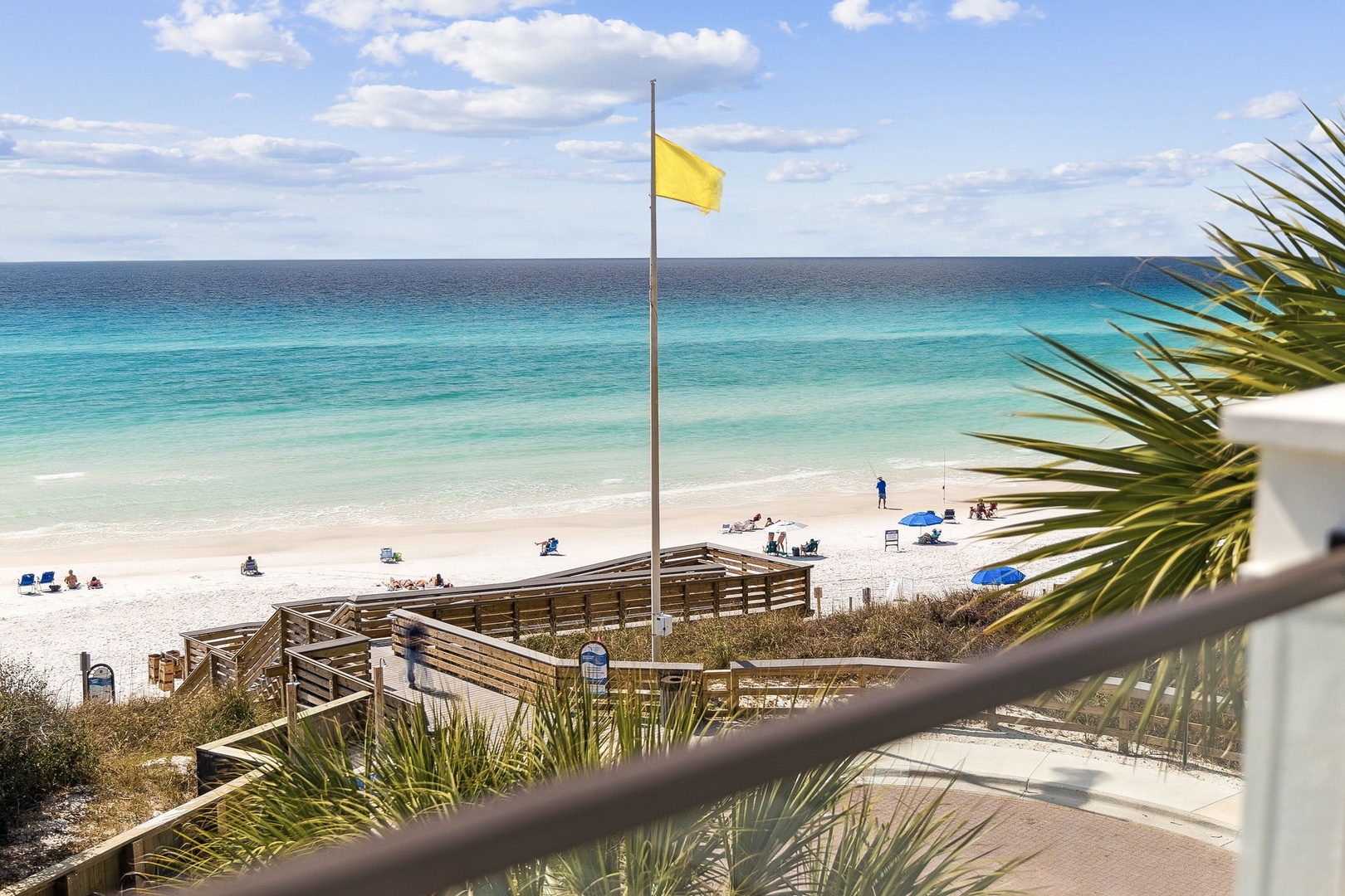 Crystal-clear turquoise waters meet pristine white sand at this stunning beachfront location with convenient boardwalk access.