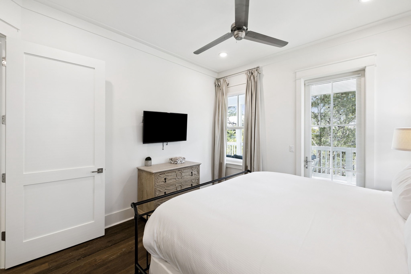 Wake up in your serene bedroom where crisp white linens meet natural light streaming through French doors to your private balcony.