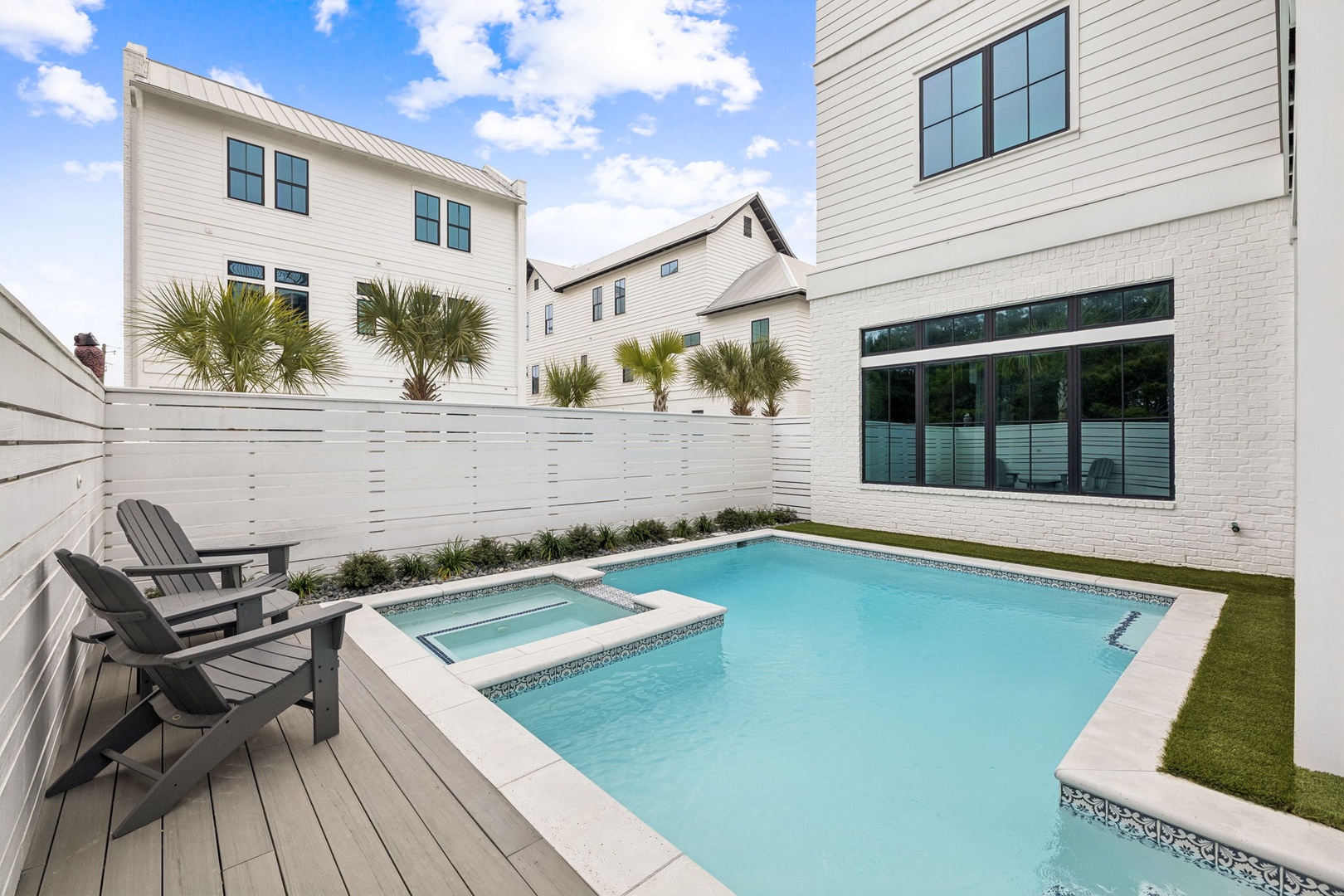 Your private backyard oasis awaits with crystal-clear pool, bubbling hot tub, and comfortable lounge seating for perfect relaxation.
