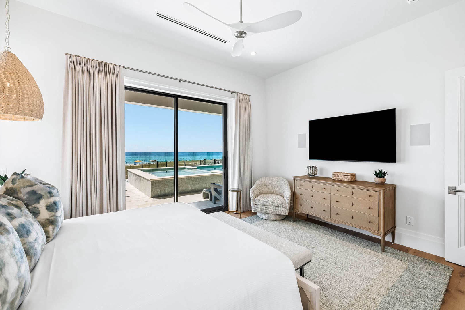 Wake up to crystal-clear ocean views from the comfort of your serene, sun-filled bedroom with direct access to the pool terrace.