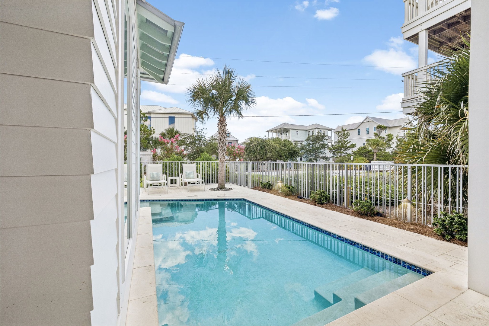 Your private pool awaits, framed by swaying palms and sunny skies—perfect for lazy afternoons and refreshing dips in your coastal retreat.