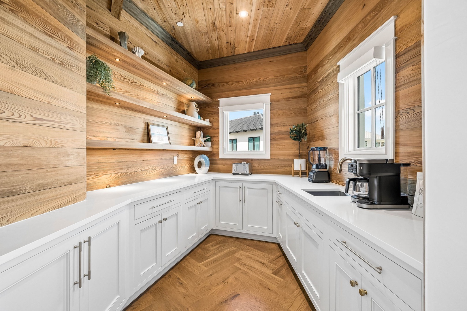 Warm wood tones meet modern comfort in this charming kitchen where you can brew morning coffee and create memorable meals surrounded by rustic elegance and natural light.