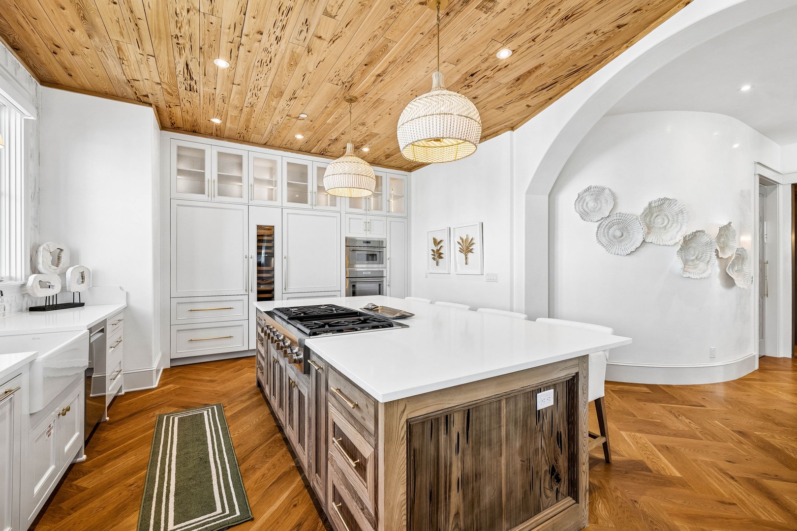 Step into your gourmet kitchen, where rustic wood ceilings meet modern elegance. Prepare meals at the spacious island with professional-grade appliances and gleaming countertops.