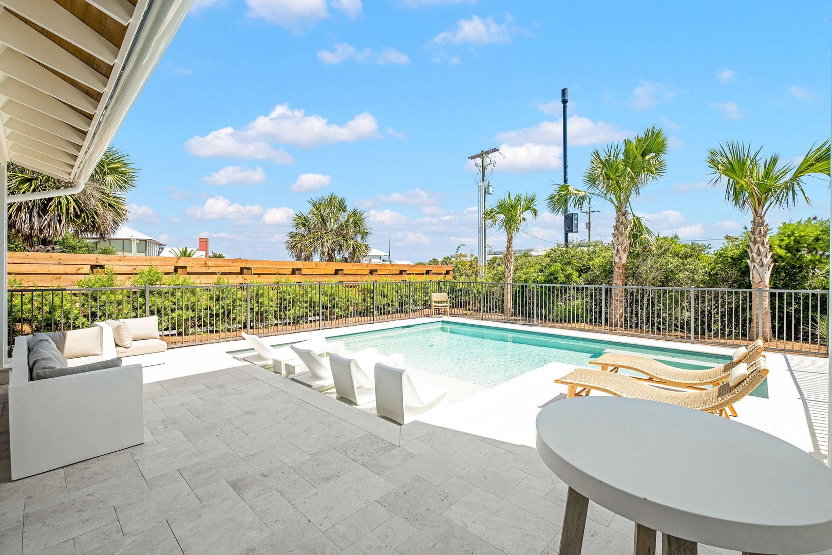 Picture yourself lounging poolside under swaying palms, soaking up the sunshine on your private deck with plenty of space to relax and entertain.