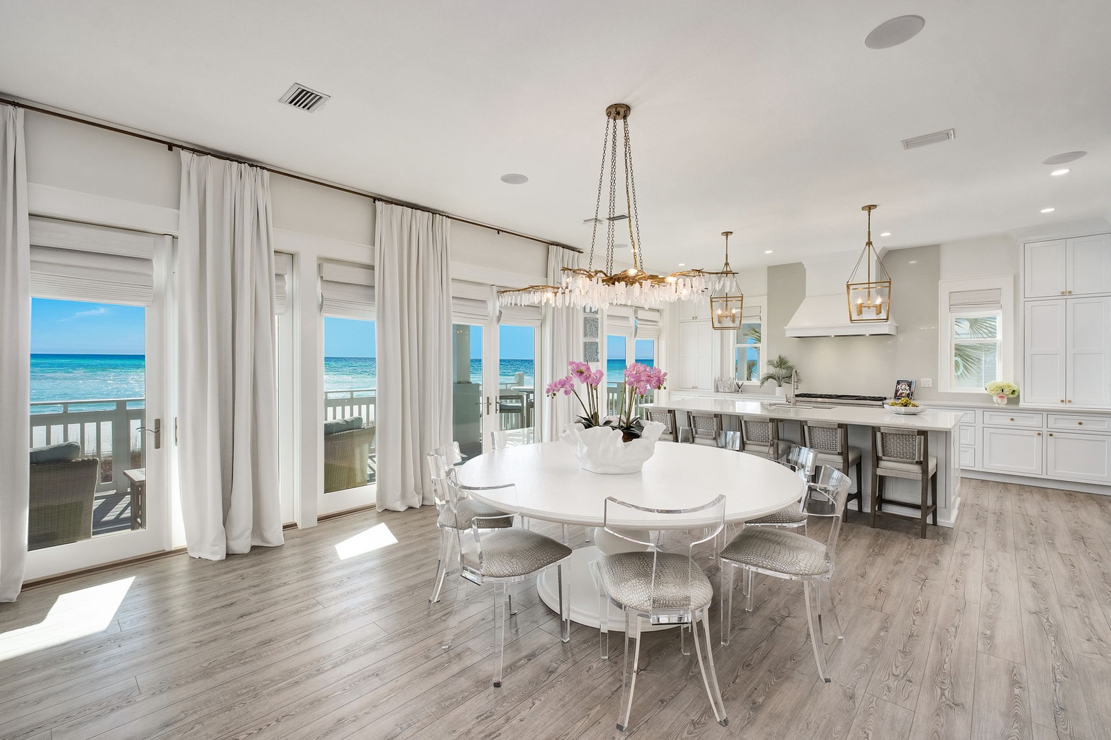 Stunning beachfront views greet you from this elegant dining and kitchen space, where coastal breezes and turquoise waters become part of your everyday dining experience.
