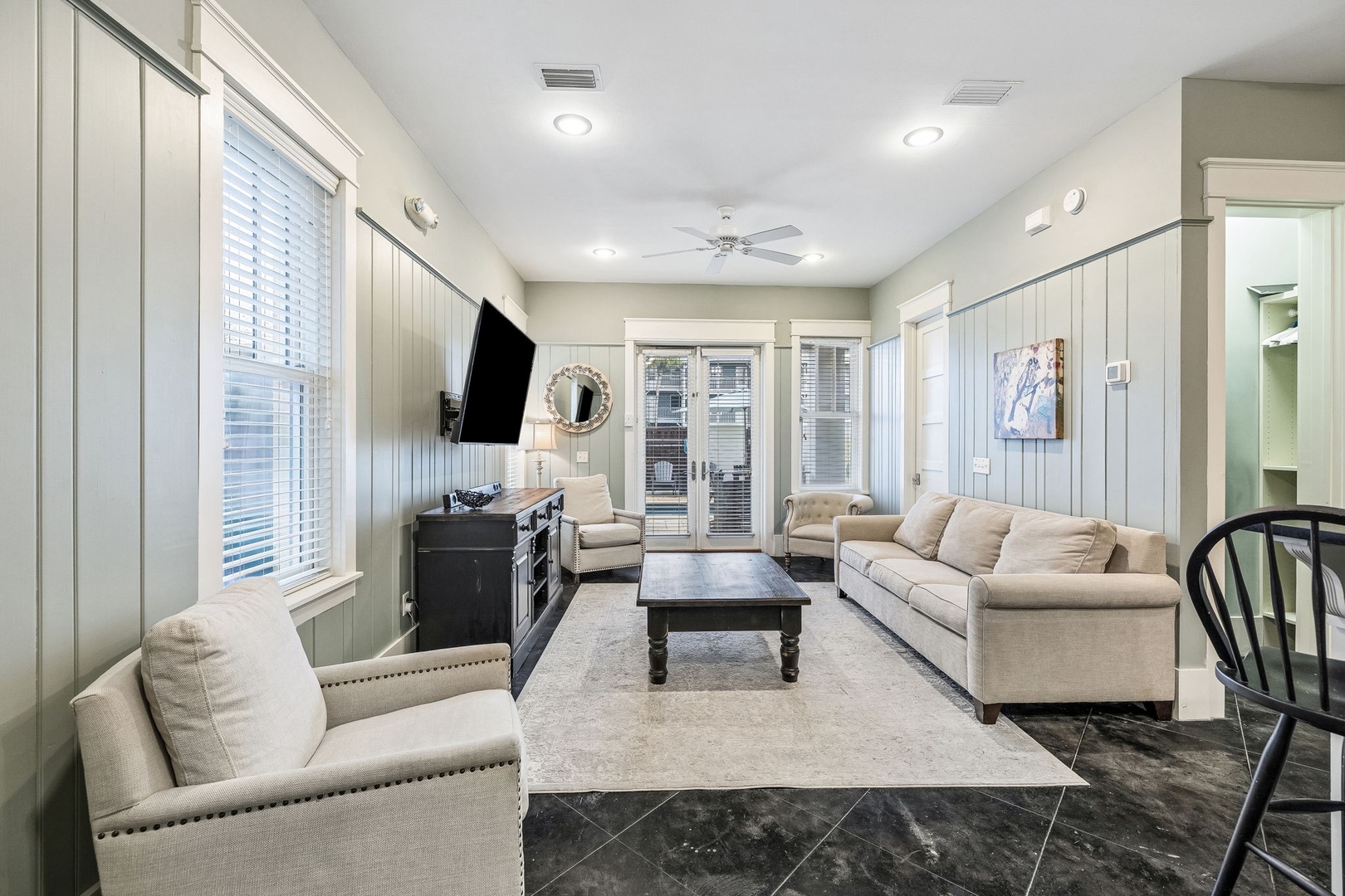 Unwind in your spacious living room with plush seating, elegant coastal-style details, and a peaceful flow that invites you to relax and feel at home.
