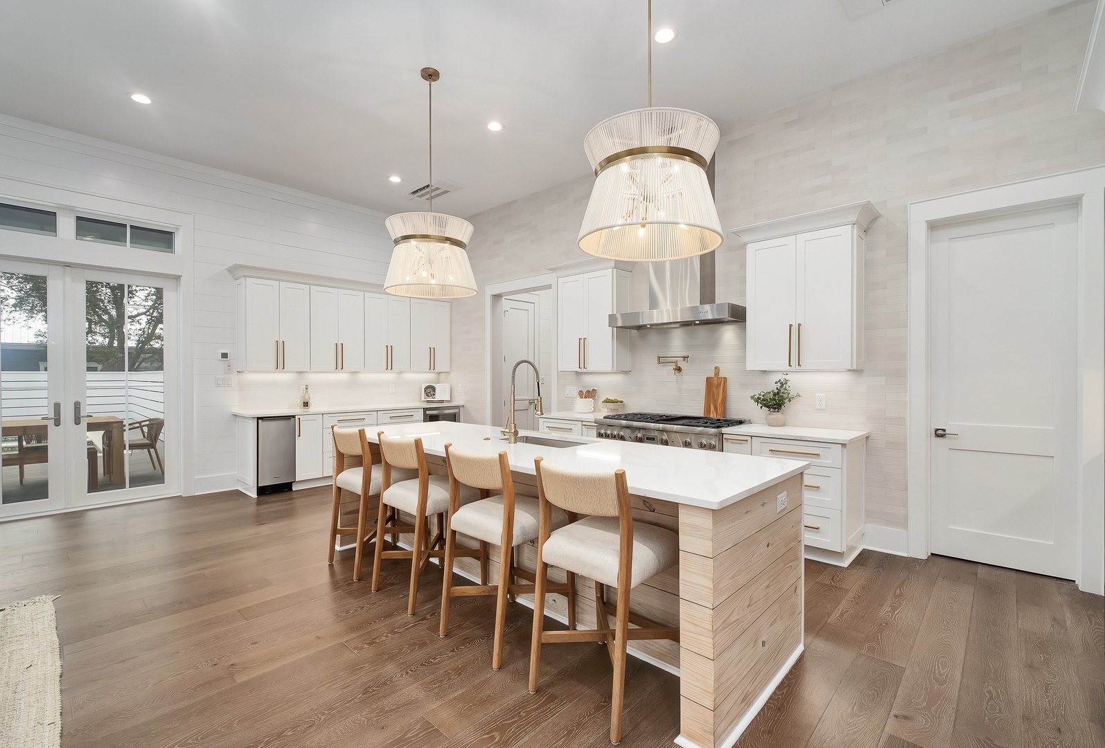 Your gourmet kitchen awaits with pristine white cabinetry, quartz countertops, and a stunning island perfect for morning coffee or evening wine.