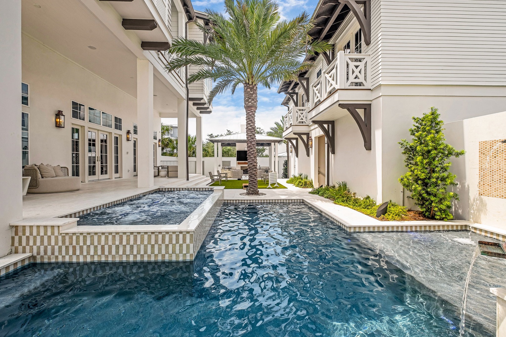 Slip into your private pool and hot tub oasis, framed by swaying palms and elegant architecture—perfect for sunny afternoons and starlit soaks.