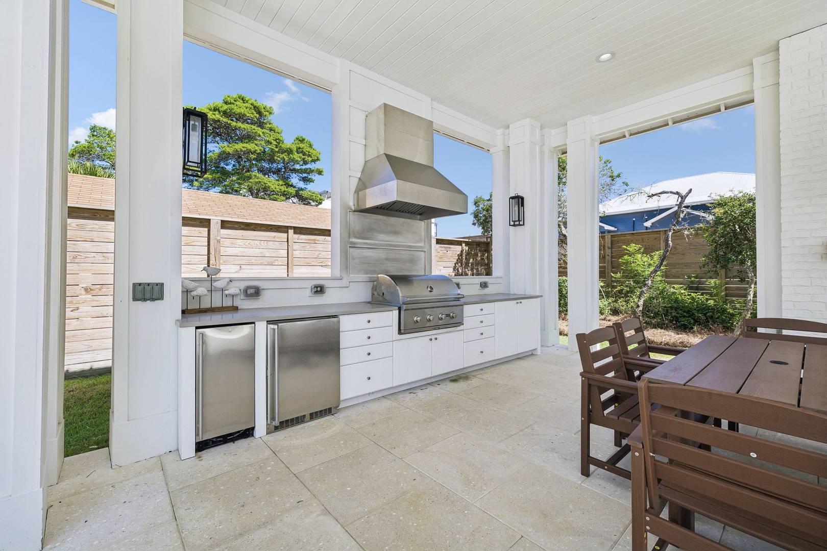 Fire up the grill in your fully equipped outdoor kitchen, where stainless-steel appliances and serene garden views set the scene for memorable meals under the open sky.