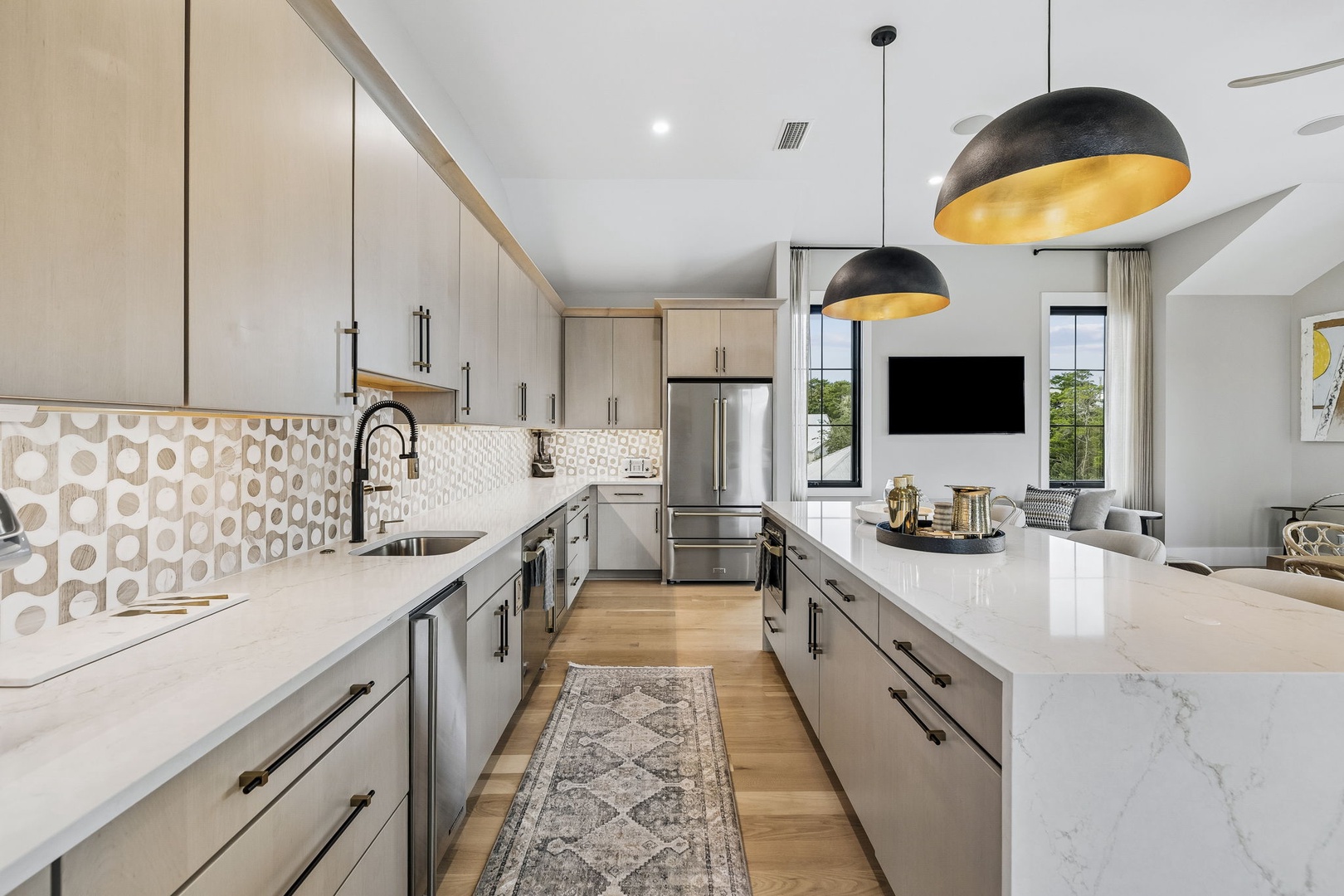 Your dream kitchen awaits with sleek marble countertops, modern fixtures, and statement pendant lighting that creates the perfect space for memorable meals and morning coffee.